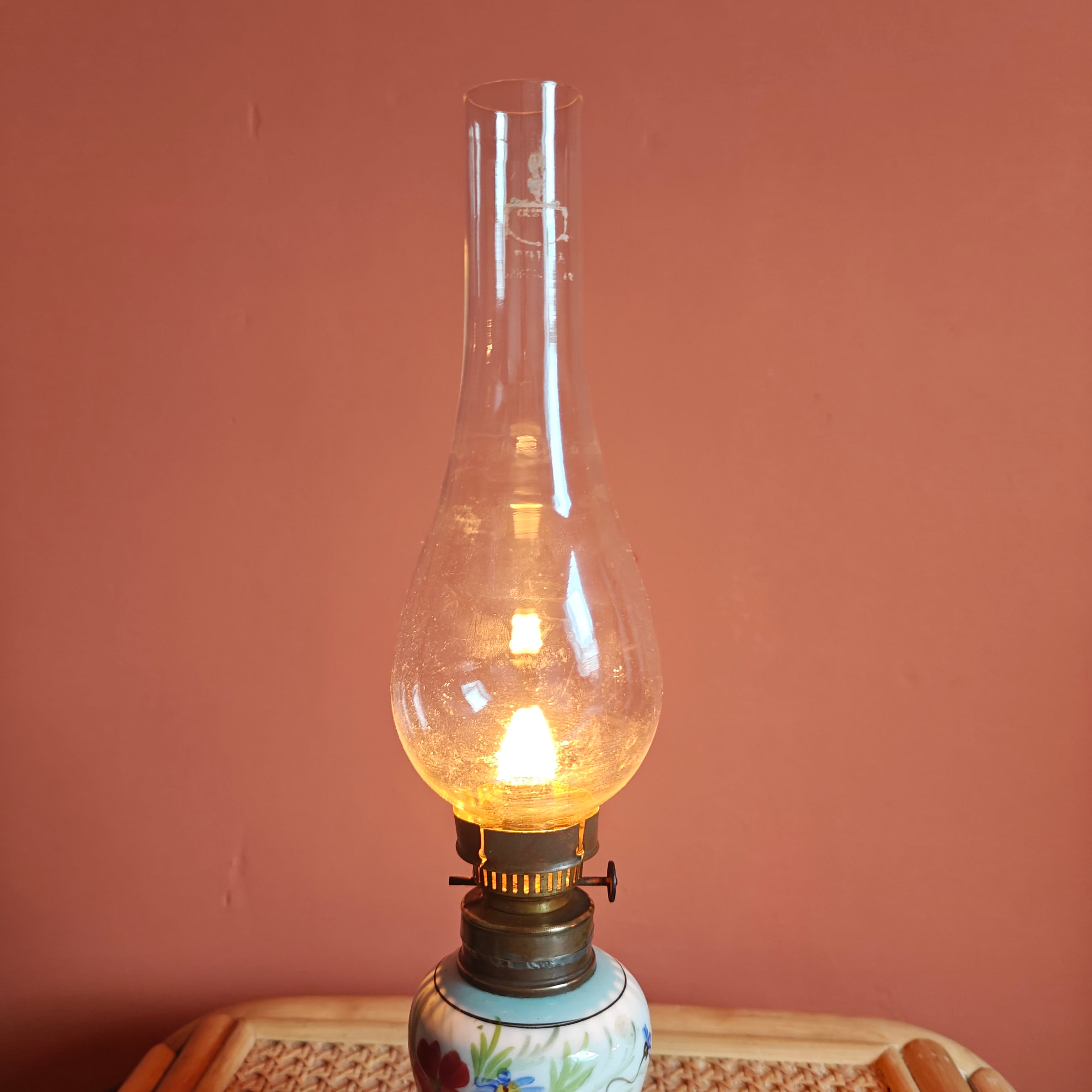 Vintage Porcelain Oil Lamp – Hand-Painted with Wiener Flachbrenner Burner glowing softly against a warm background