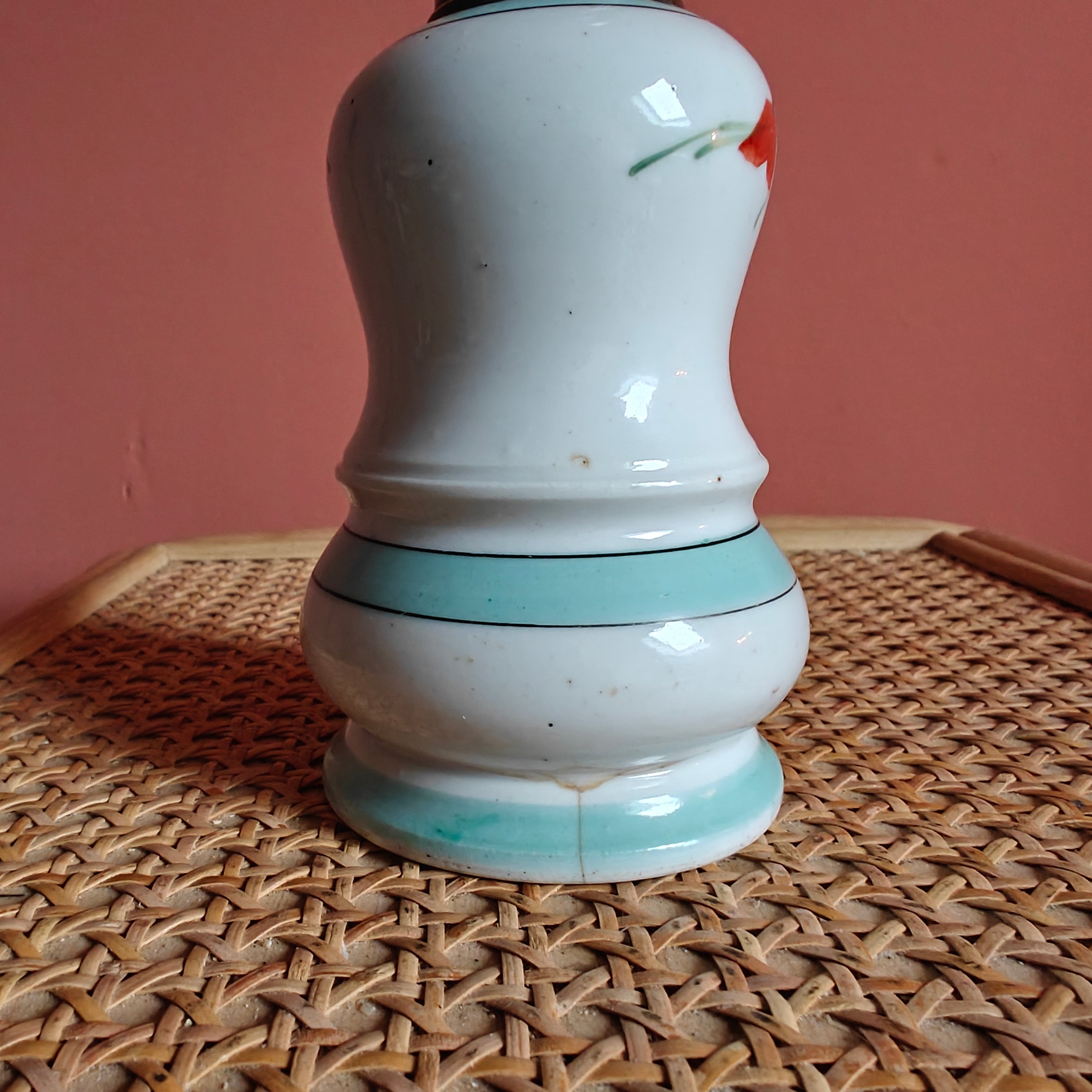 Close-up of the base of the Vintage Porcelain Oil Lamp – Hand-Painted with Wiener Flachbrenner Burner on a woven surface