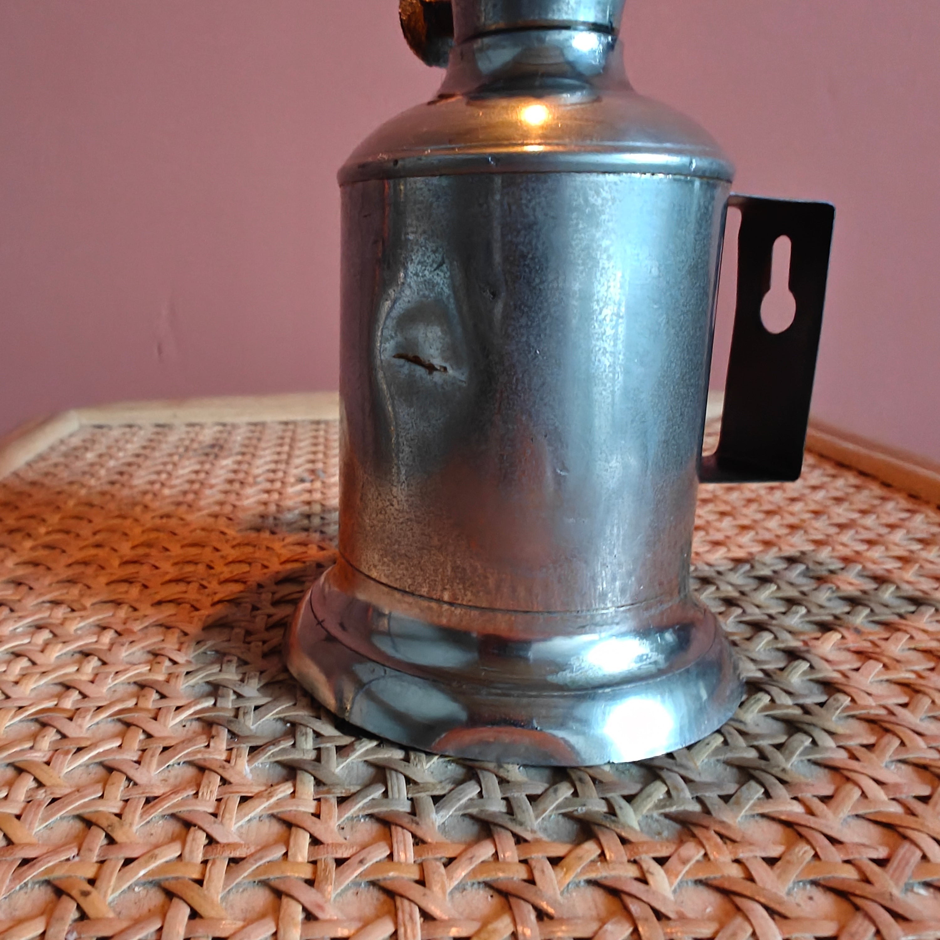 Vintage French Oil Lamp – Pigeon Style with T.F. Déposé Burner (17 cm) in a metallic silver finish on wicker surface
