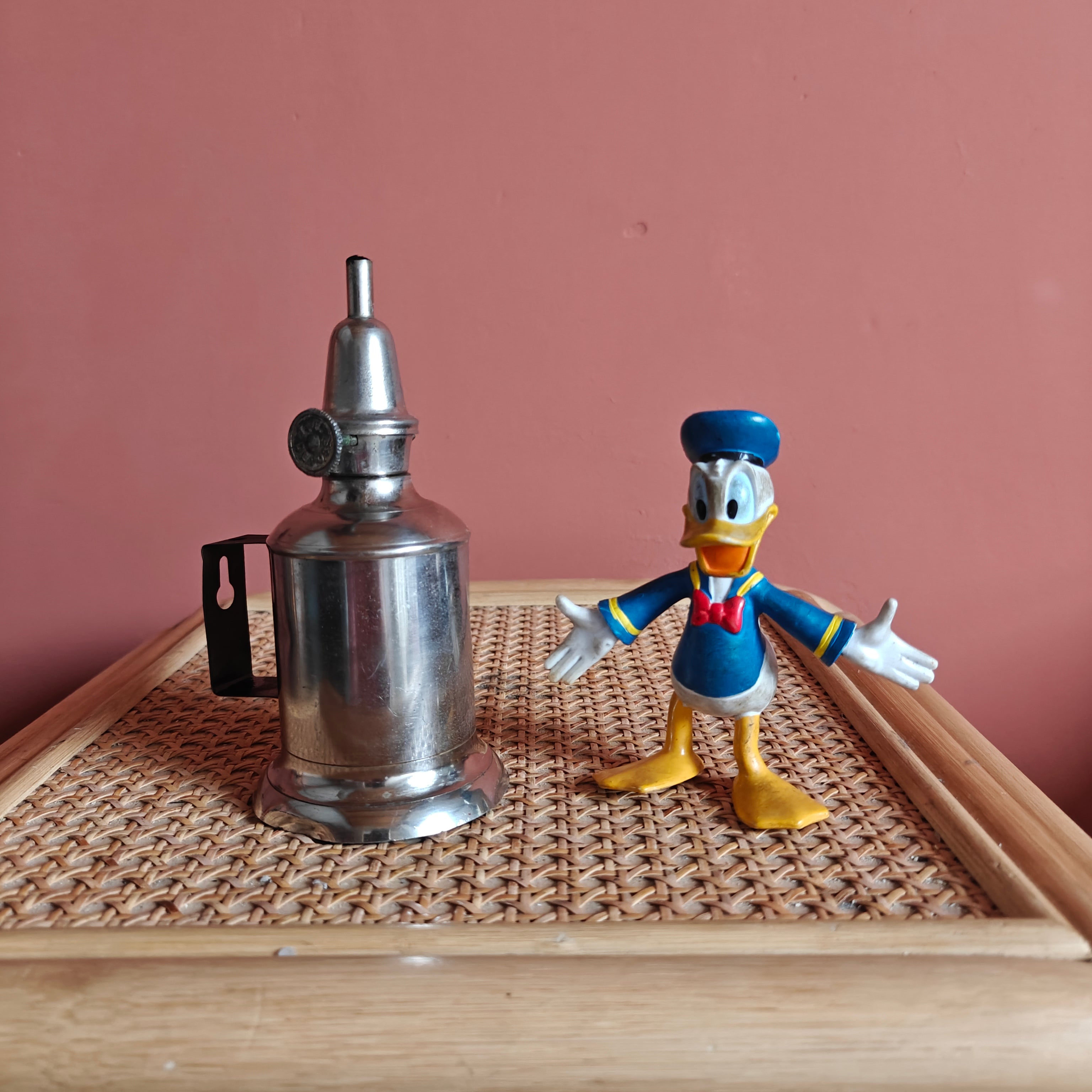 Vintage French Oil Lamp – Pigeon Style with T.F. Déposé Burner (17 cm) displayed on wicker surface next to a figurine.