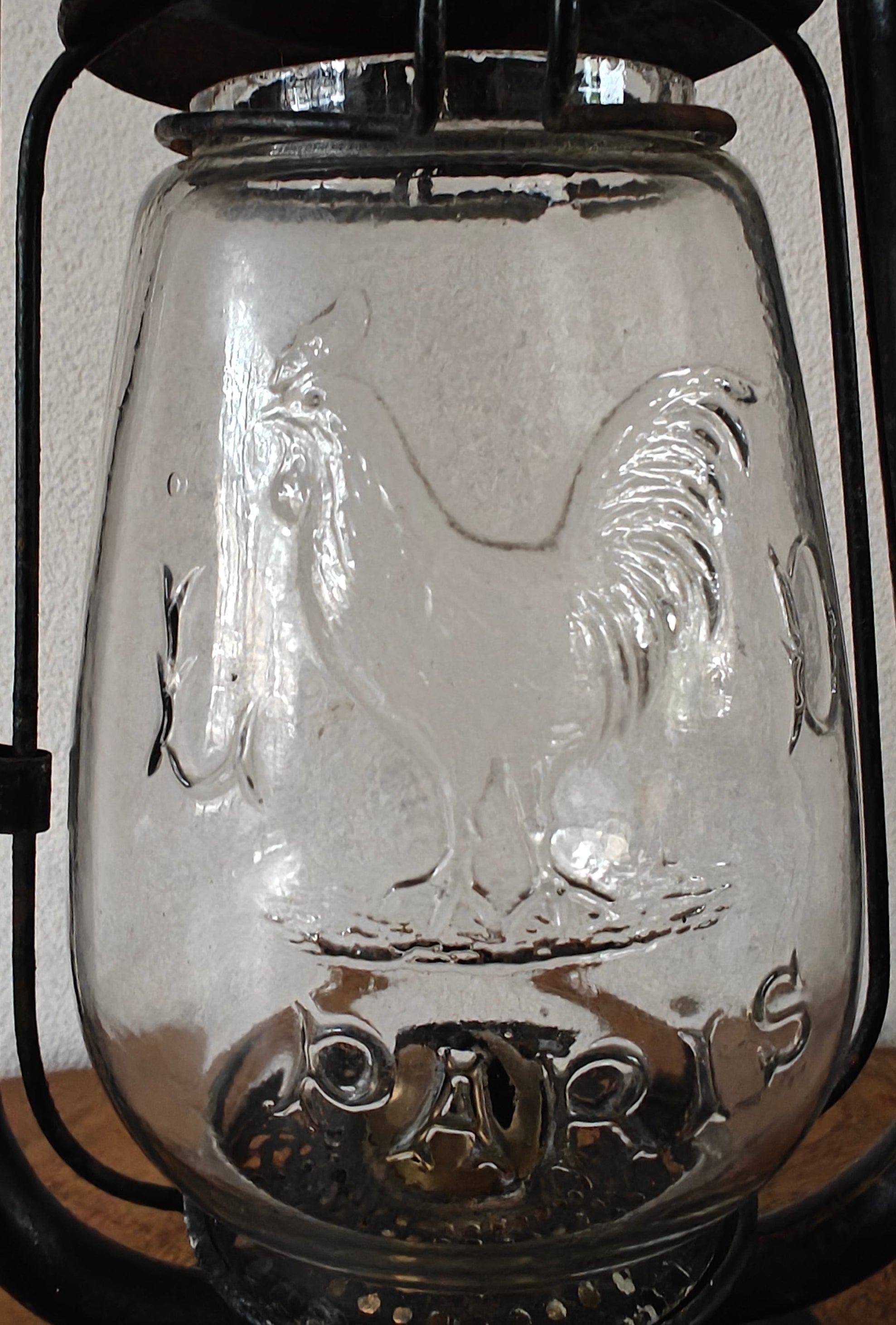 Vintage glass oil lamp with embossed rooster design and the word Paris on the front panel
