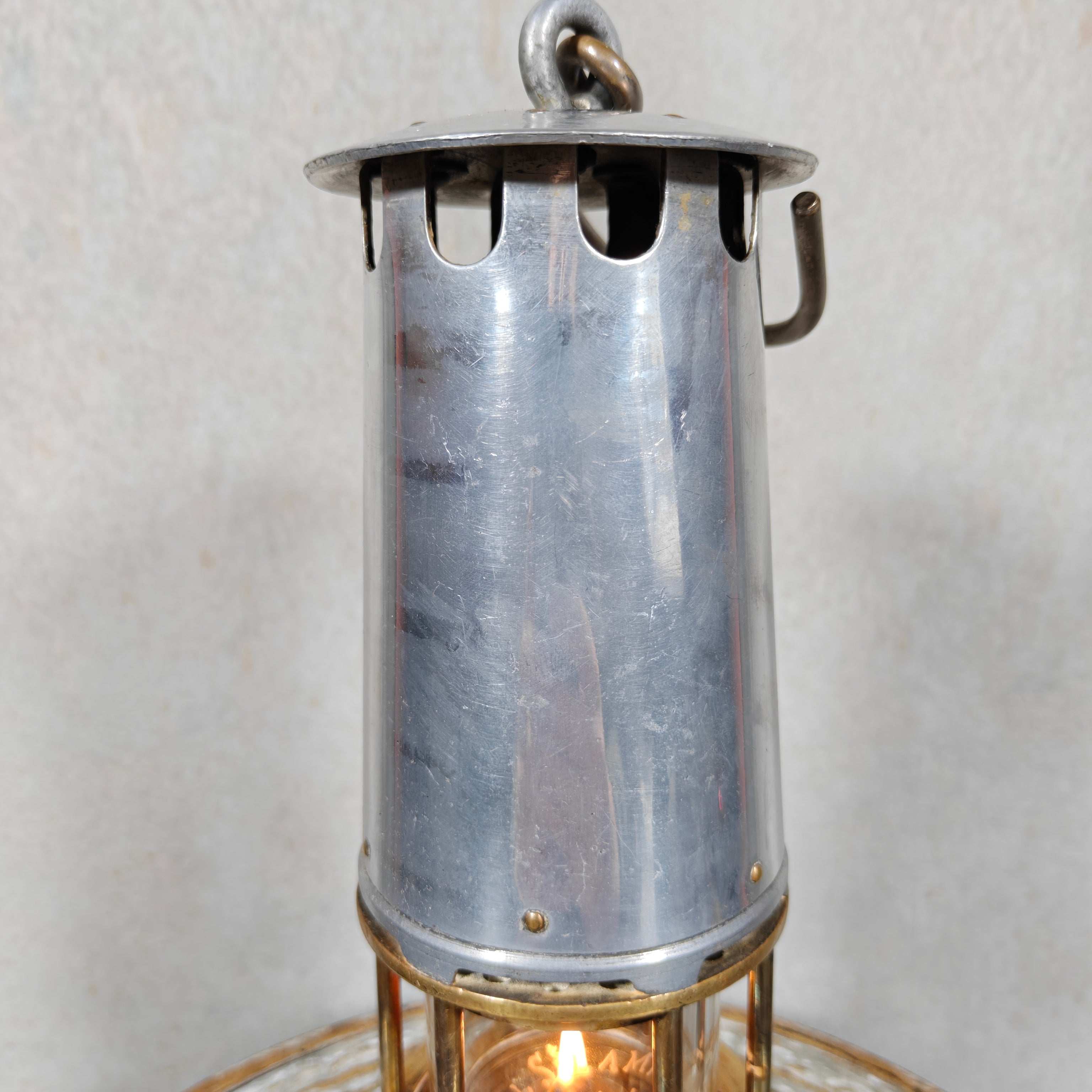Beautiful, Miner’s Lamp – ca. 1900 – With Val St. Lambert D.S.4 Glass oil lamp featuring vintage metal design and glowing flame inside.