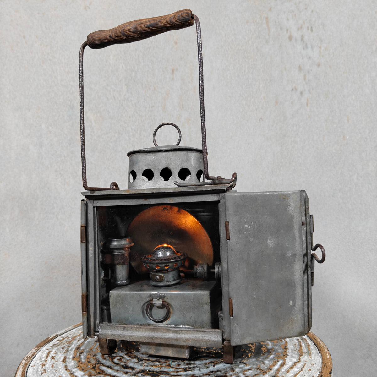 Very Rare Oil and Candle Trench Lamp – “Weltlaterne” by J. Schwarz & Co., Berlin, 1910–1920, showing oil lamp inside open metal case.