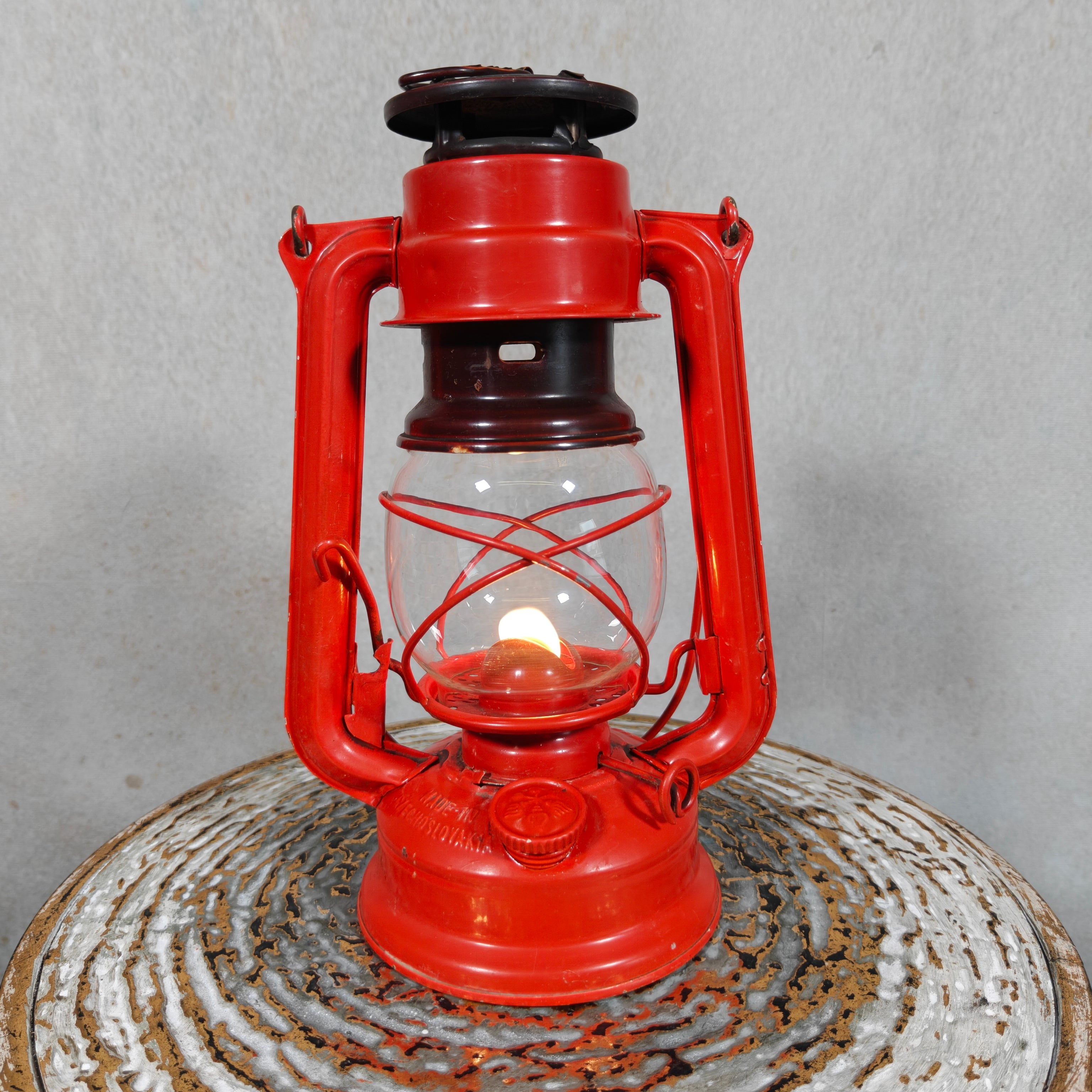 Beautiful and Functional Czech Storm Lantern – Meva 863 (1980) red oil lamp with flame, classic Czech brand design.