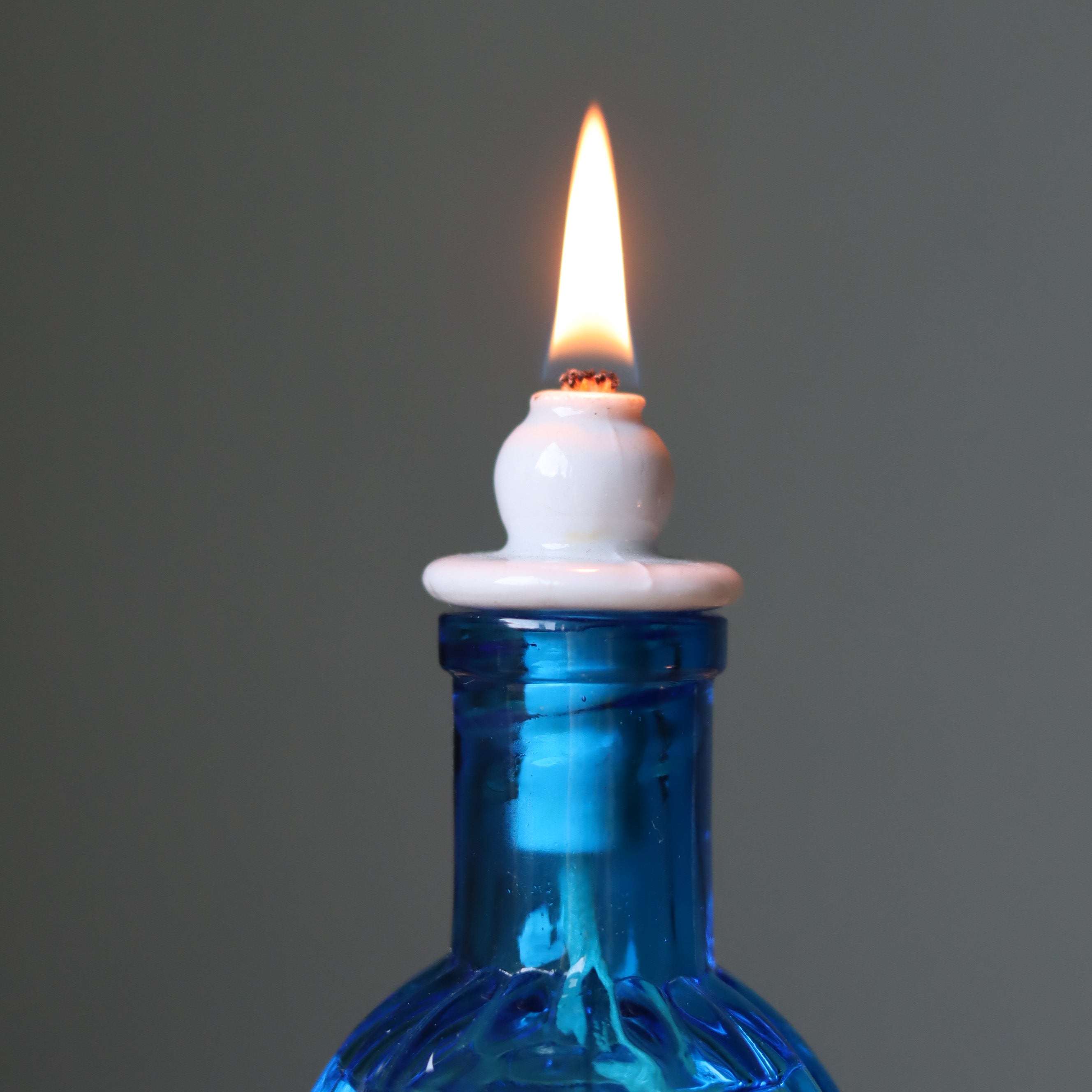 Rare Vintage French Oil Lamp – Blue Glass Bedside Nightlight (1930s–1950s) with lit flame on blue glass reservoir
