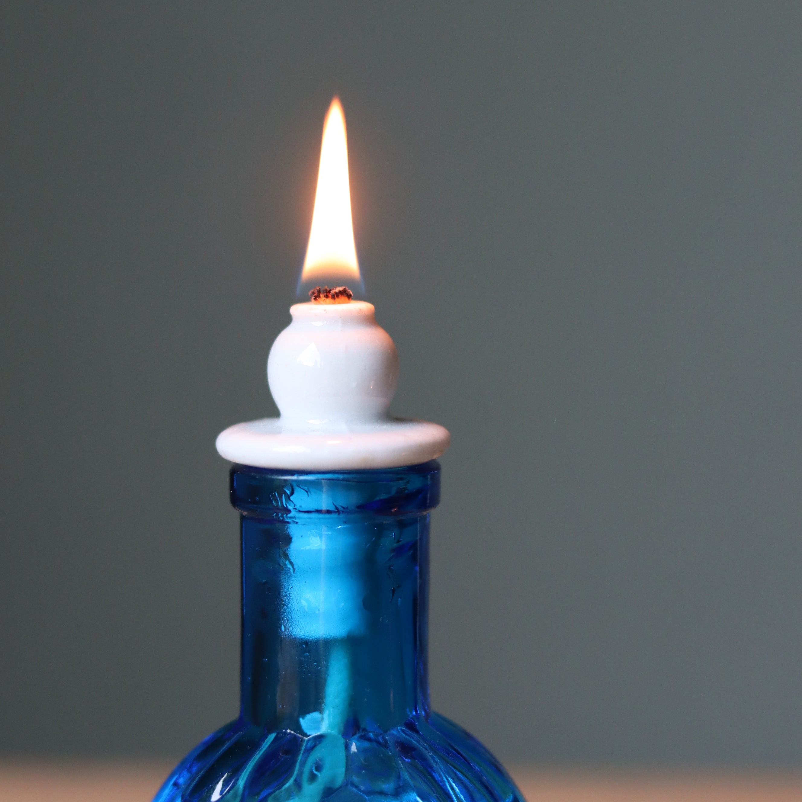 Rare Vintage French Oil Lamp – Blue Glass Bedside Nightlight (1930s–1950s) burning with elegant blue glass reservoir.