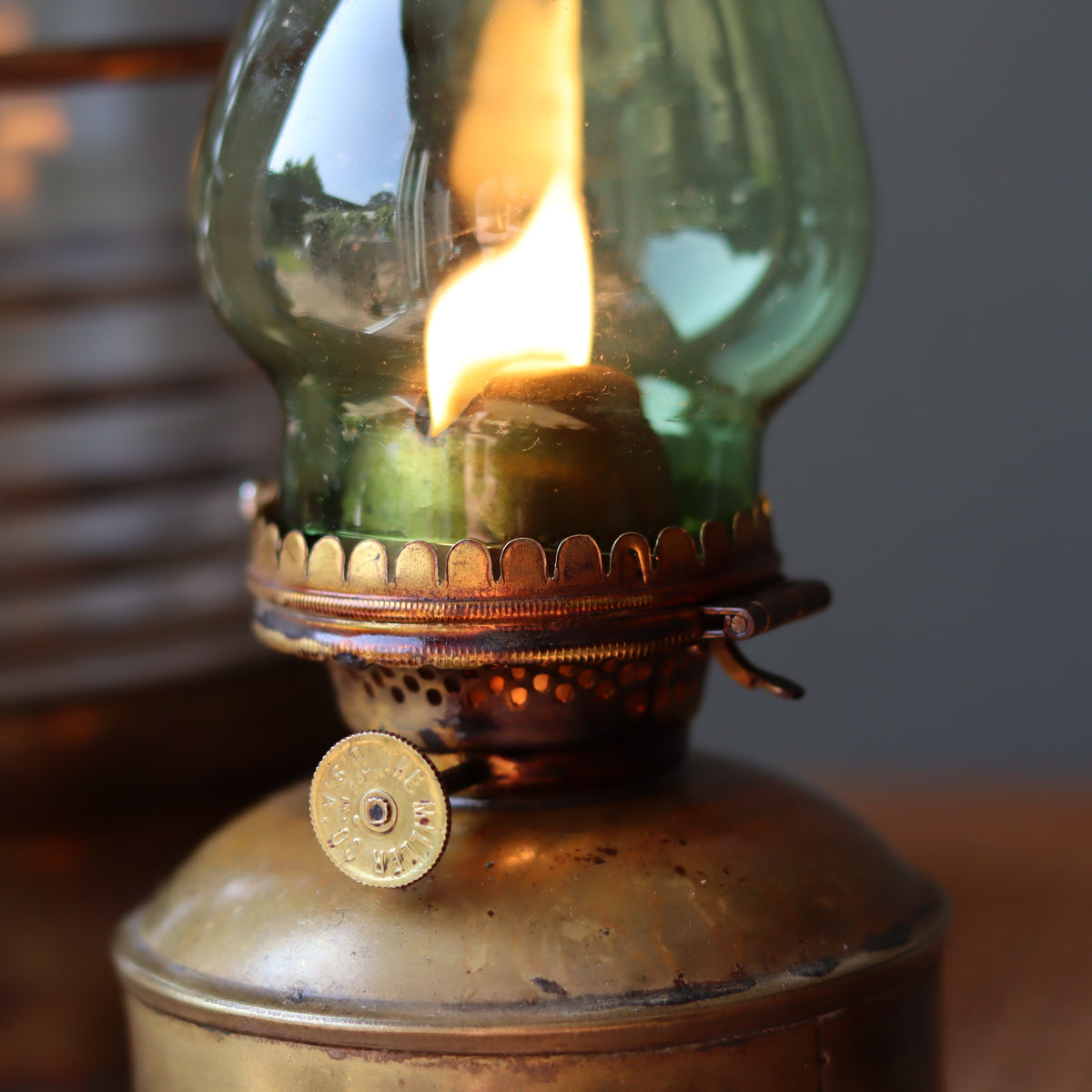 Close-up of a burning oil lamp in the Vintage Perko Ship’s Lantern – Anchor Light (Copper, Brass & Bronze) maritime decor piece