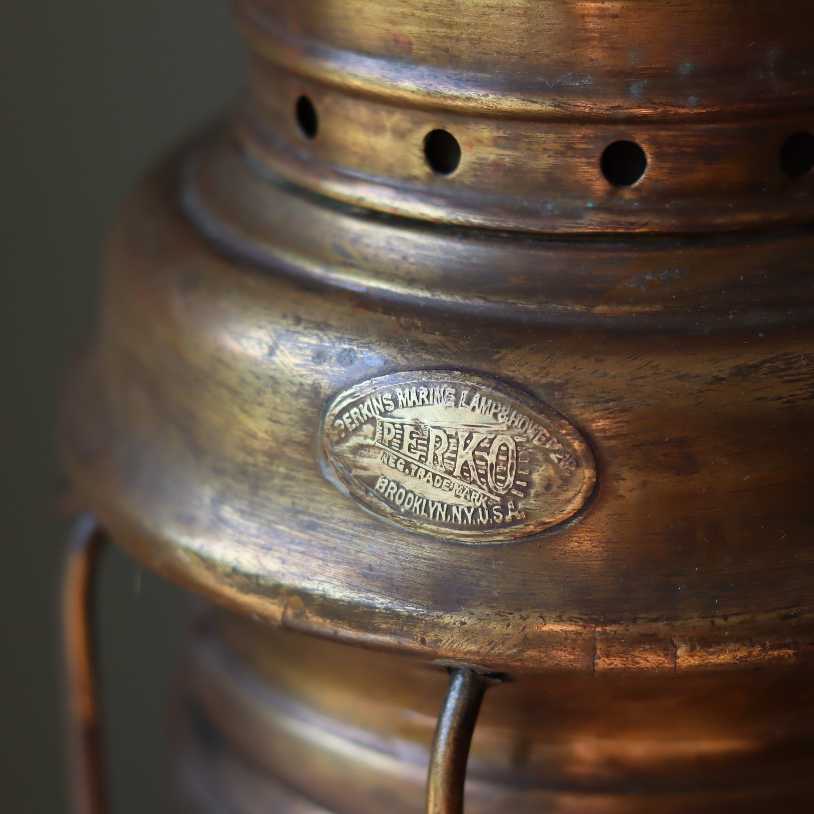 Close-up of the Vintage Perko Ship’s Lantern – Anchor Light (Copper, Brass & Bronze) showcasing the Perko brand label on the oil lamp.