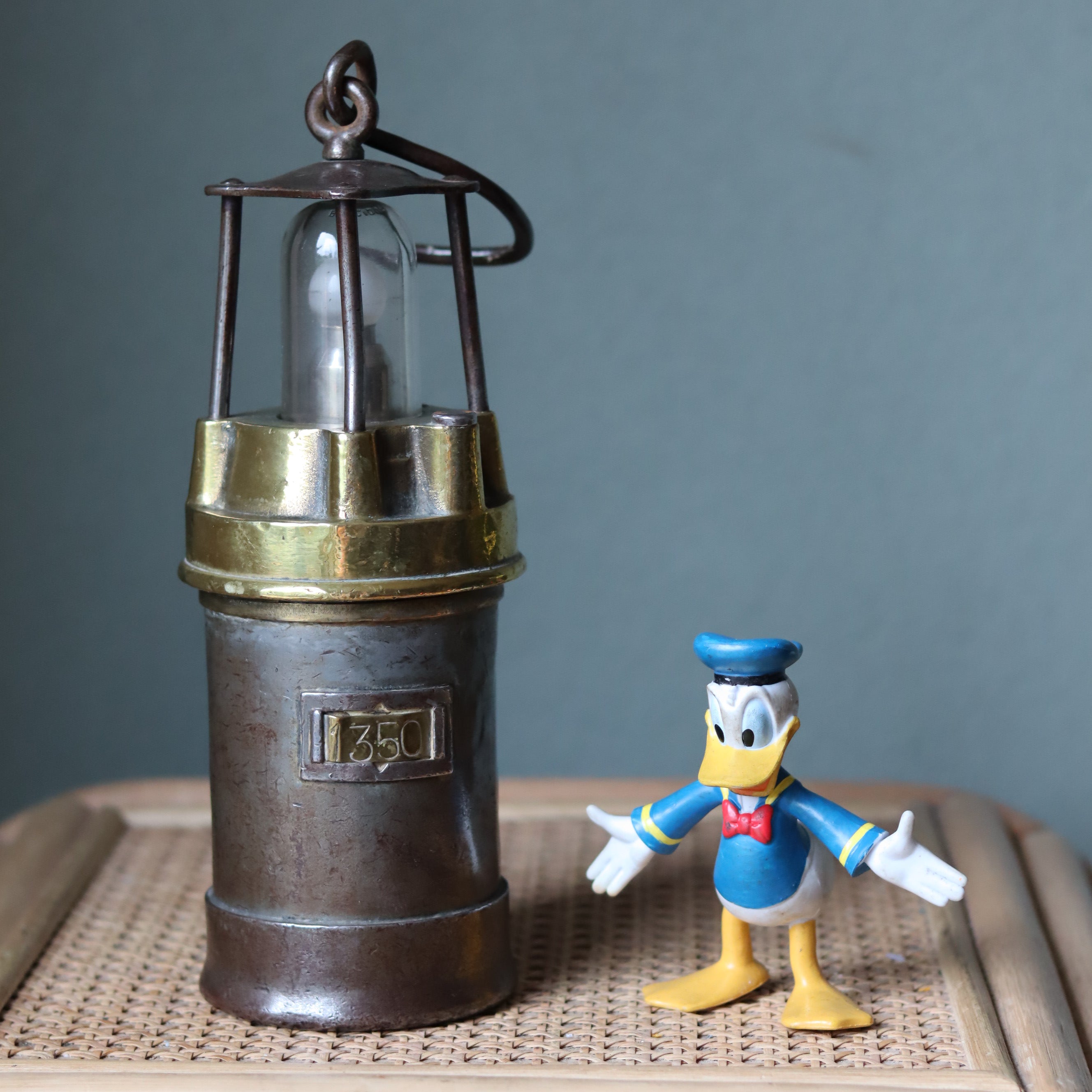 Vintage Mining Lamp – Pot Lamp – Numbered 1350 – Bronze and Steel oil lamp from the 1950s–1960s era displayed on a table.