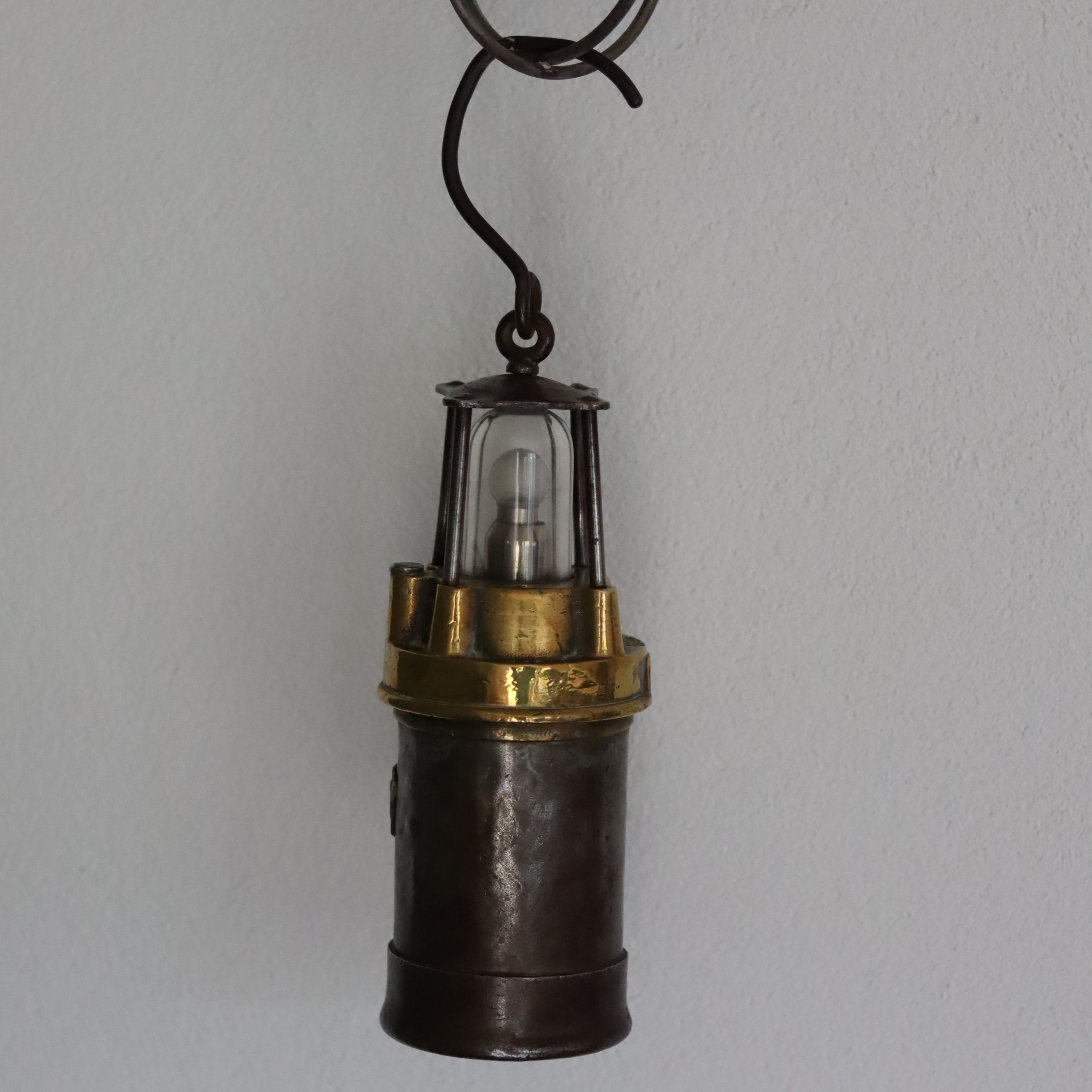 Vintage Mining Lamp – Pot Lamp – Numbered 1350 – bronze and steel oil lamp from the 1950s–1960s era hanging on wall