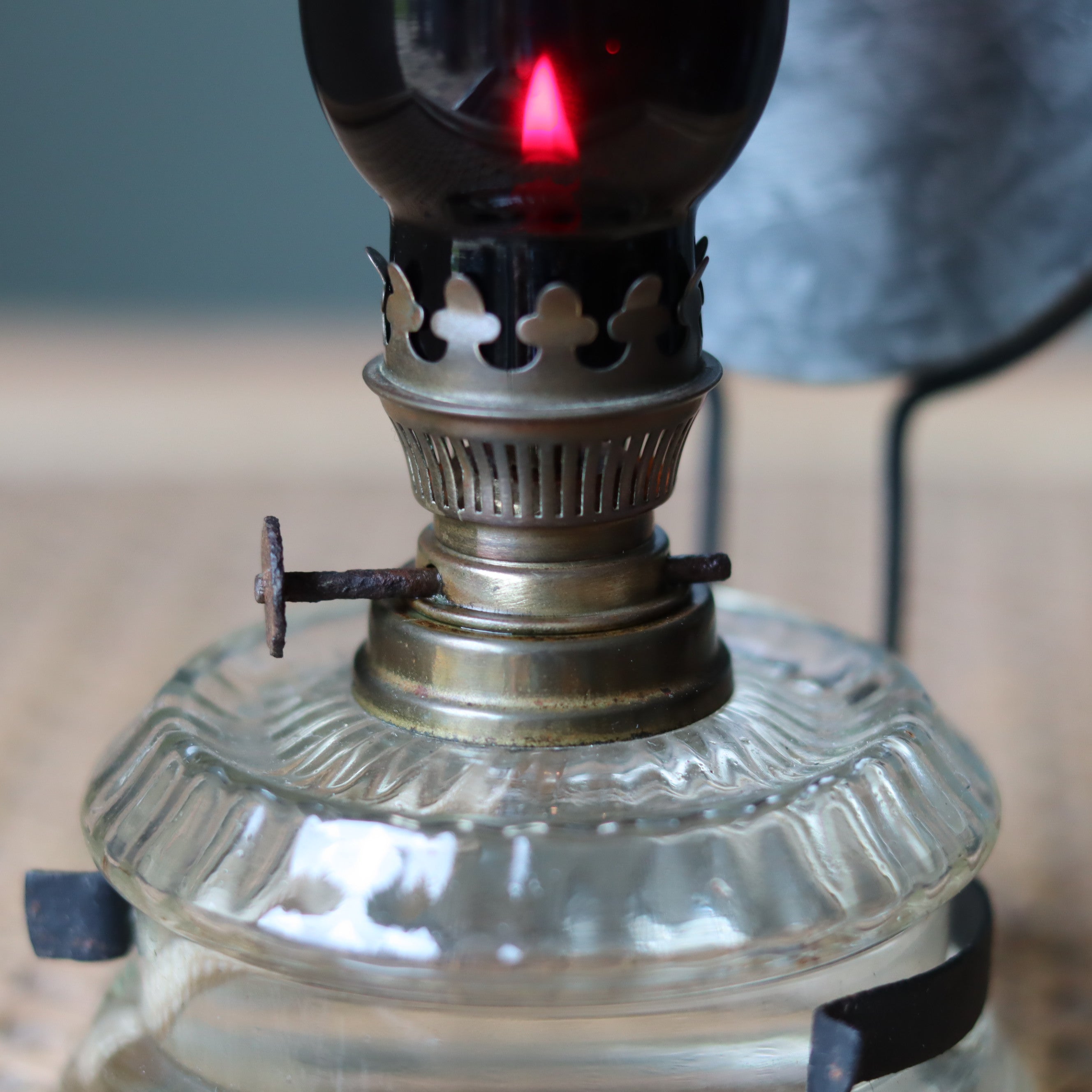 Rare Vintage Wall Oil Lamp – Red Glass Chimney by Gebr Putzler Kitchen Lamp from 1900s–1950s lit with flame close-up