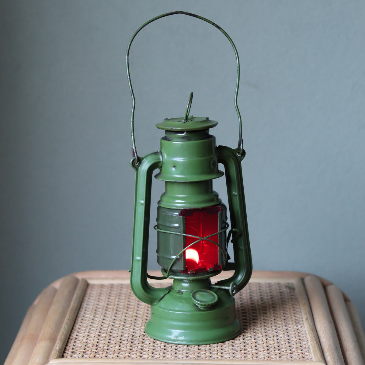 Rare Vintage Jupiter-1 Green Hurricane Lantern – Unique Flat Glass Holder with Red and Clear Panels oil lamp on wicker surface