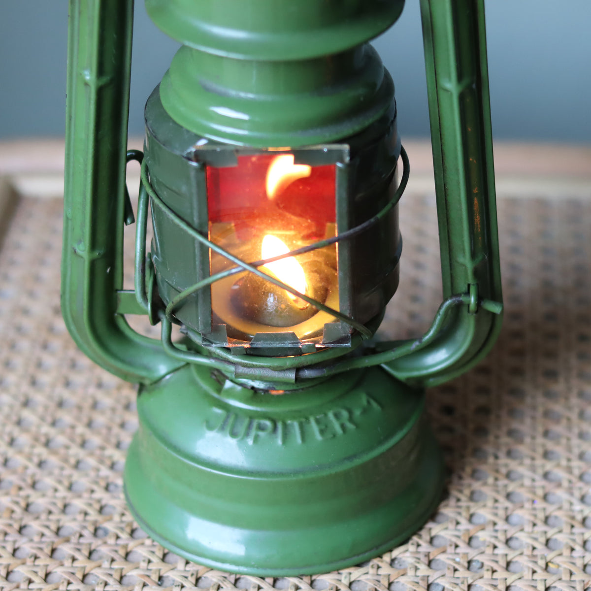 Rare Vintage Jupiter-1 Green Hurricane Lantern – Unique Flat Glass Holder with Red & Clear Panels oil lamp lit close-up view