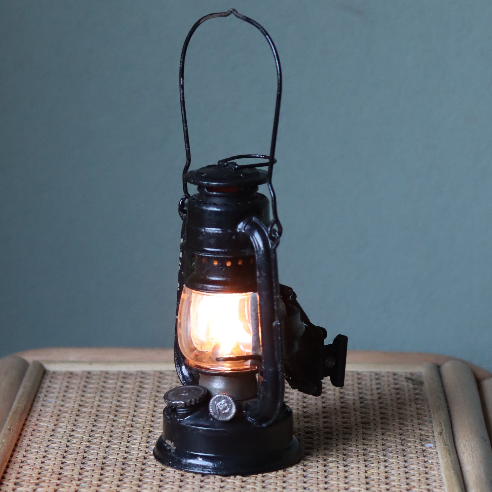 Rare Pre-War Bicycle Storm Lantern – Feuerhand 175F Superbaby oil lamp glowing with original glass and rear red lens detail