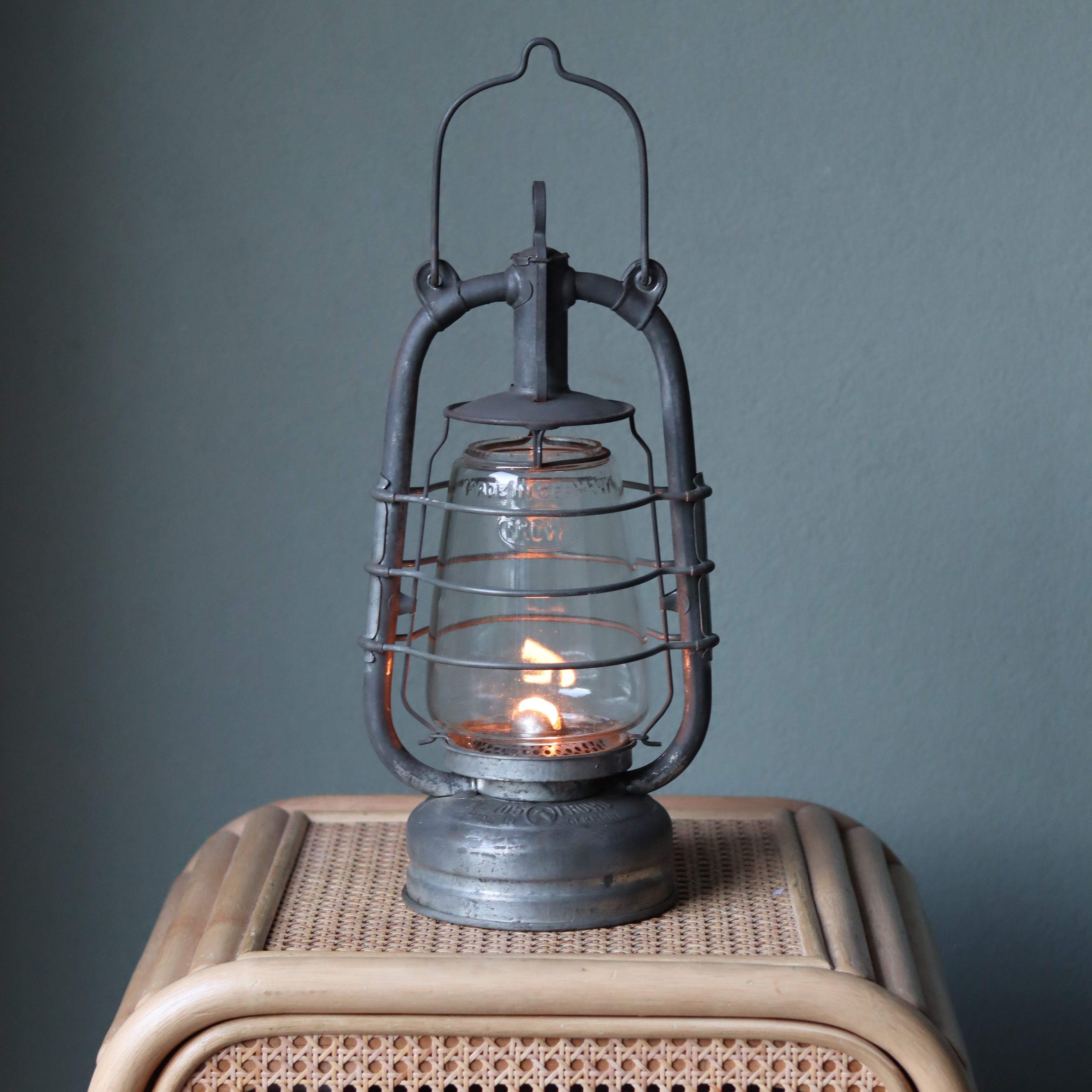 Rare Vintage Frowo 105 Hurricane Lantern – Pre-War/short post war Model with Dog Emblem oil lamp glowing on wicker surface