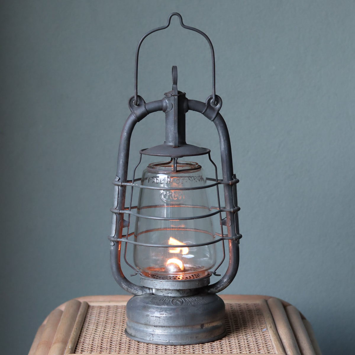 Rare Vintage Frowo 105 Hurricane Lantern – Pre-War/short post war Model with Dog Emblem oil lamp lit on wicker table