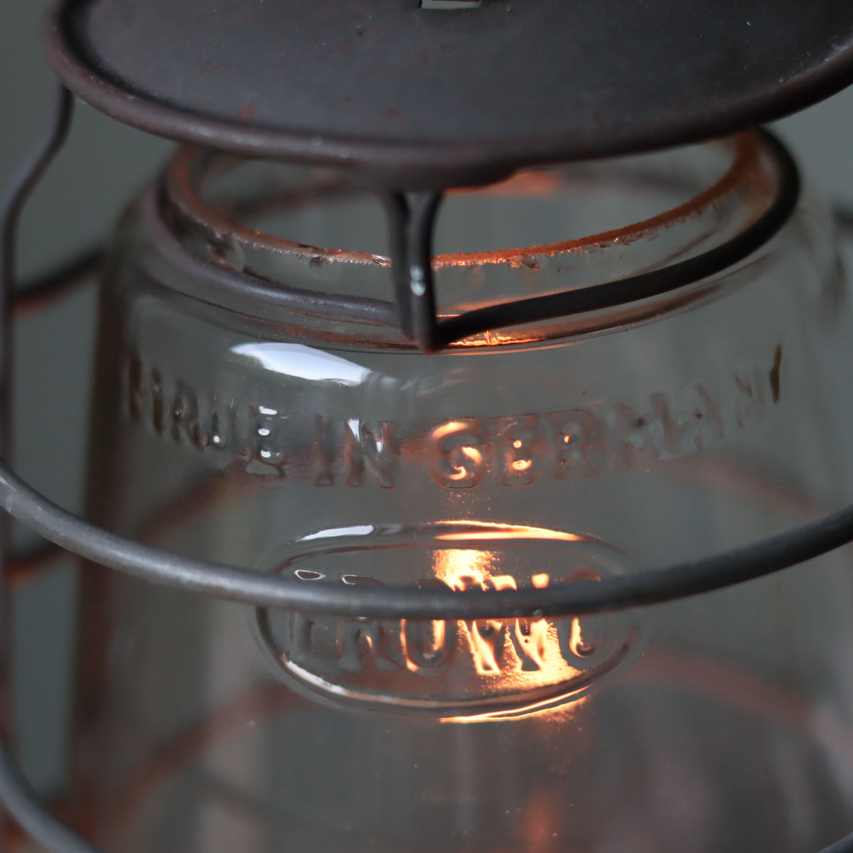 Rare Vintage Frowo 105 Hurricane Lantern – Pre-War/short post war Model with Dog Emblem close-up of lit oil lamp glass detail