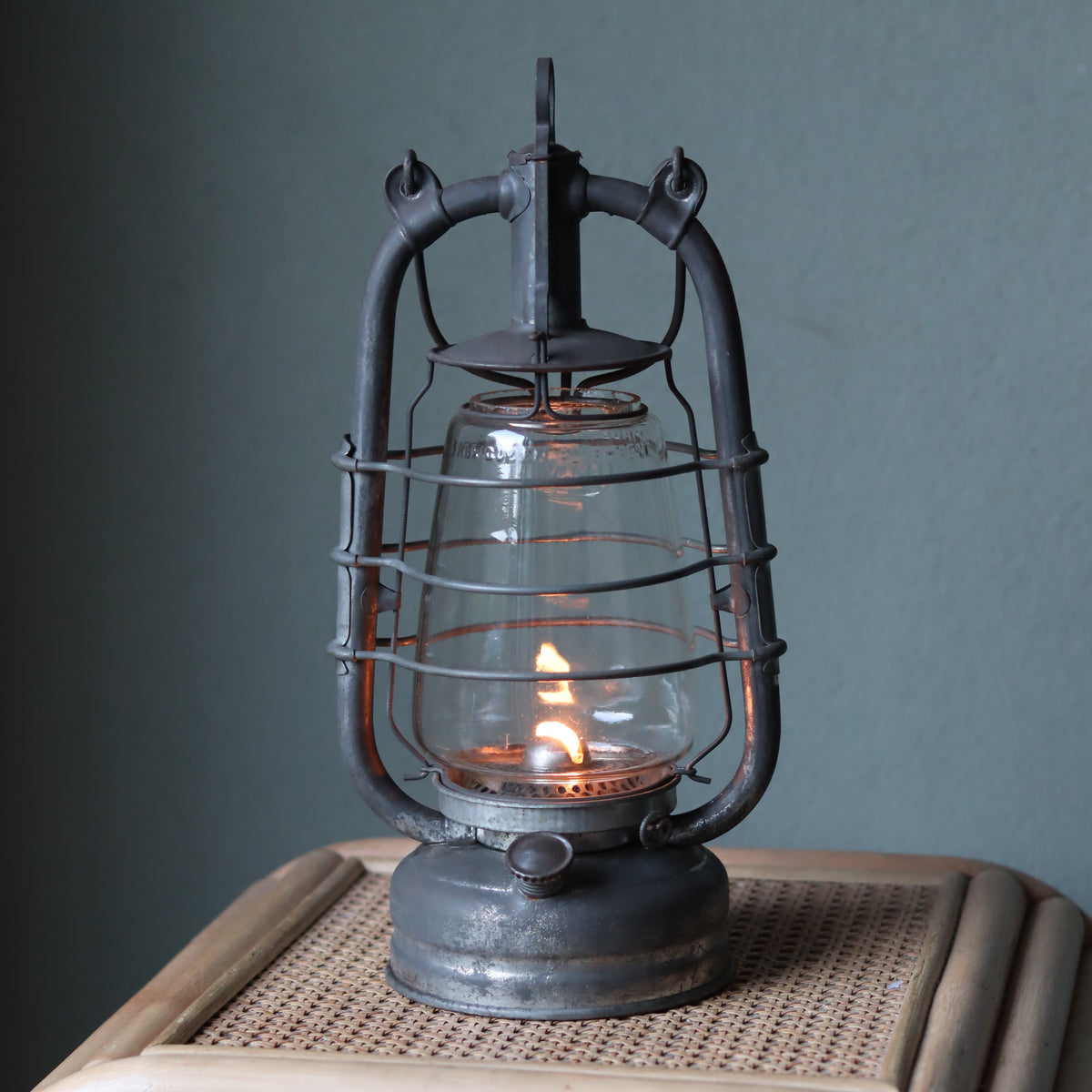 Rare Vintage Frowo 105 Hurricane Lantern – Pre-War/short post war Model with Dog Emblem lit vintage oil lamp on wicker table