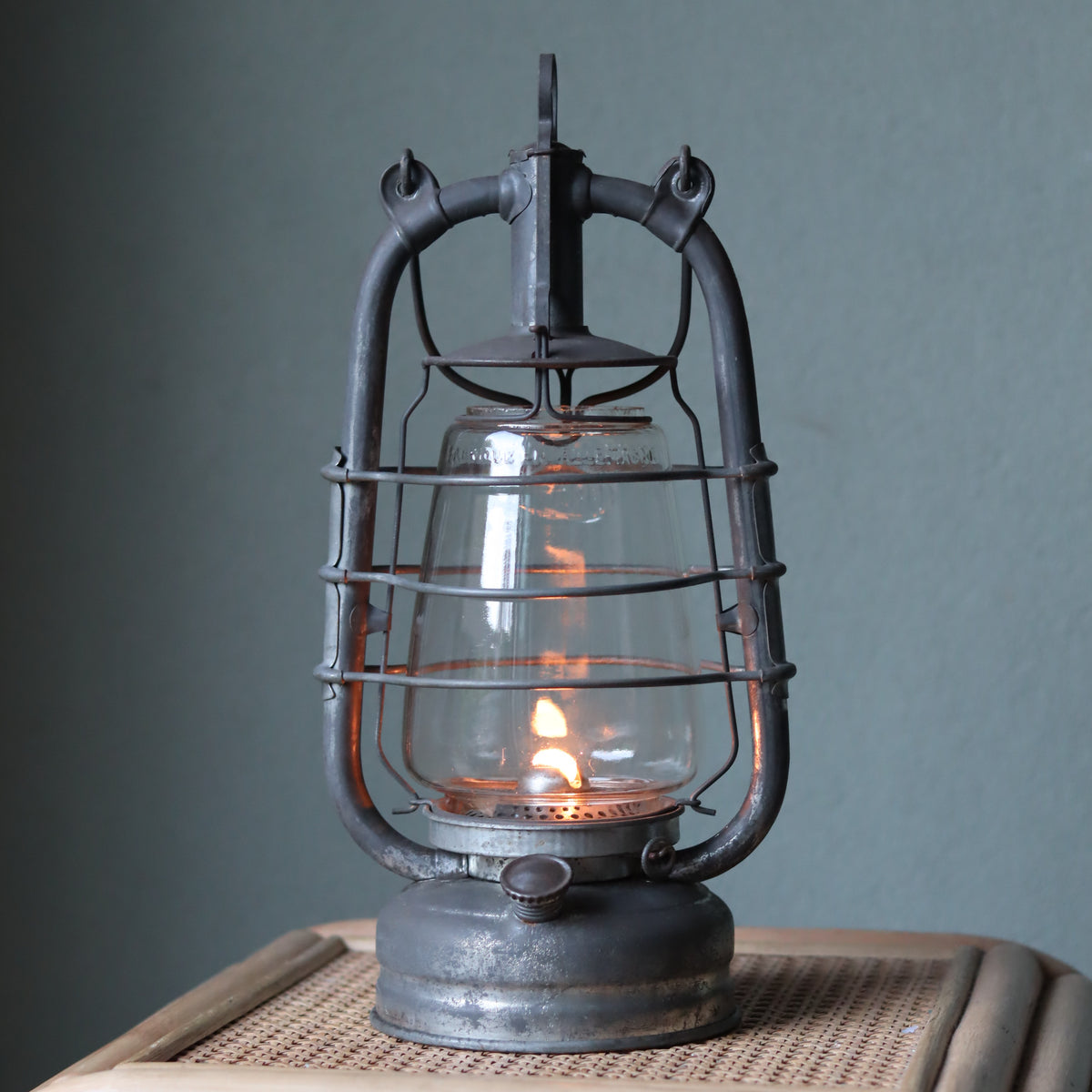 Rare Vintage Frowo 105 Hurricane Lantern – Pre-War/short post war Model with Dog Emblem oil lamp lit on wooden surface