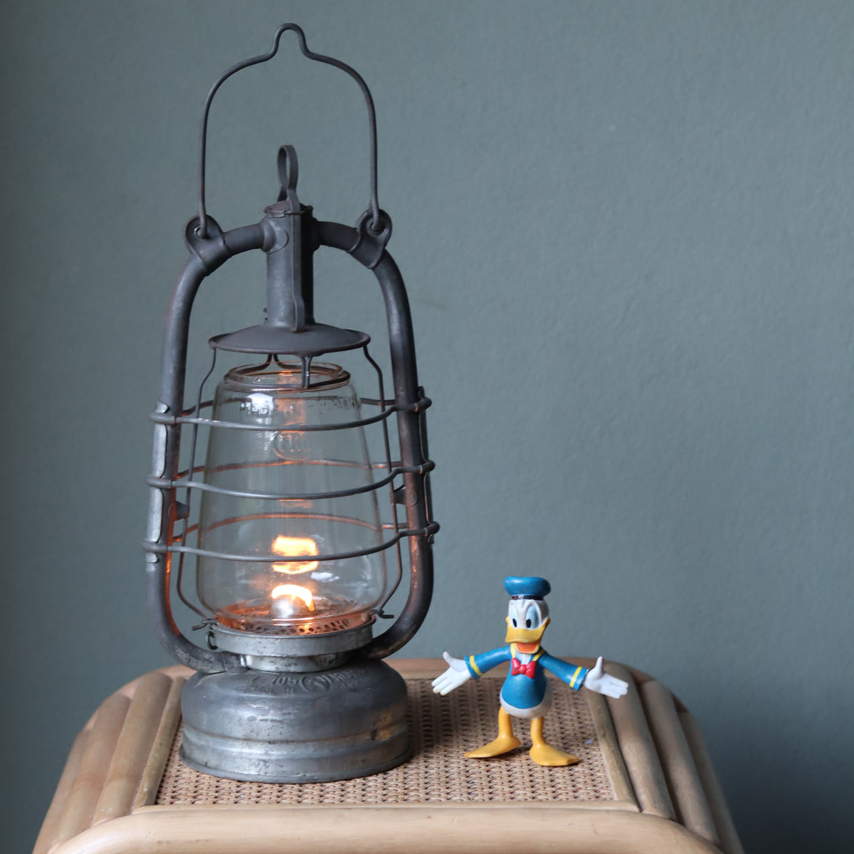 Rare Vintage Frowo 105 Hurricane Lantern – Pre-War/short post war Model with Dog Emblem oil lamp lit on wooden surface