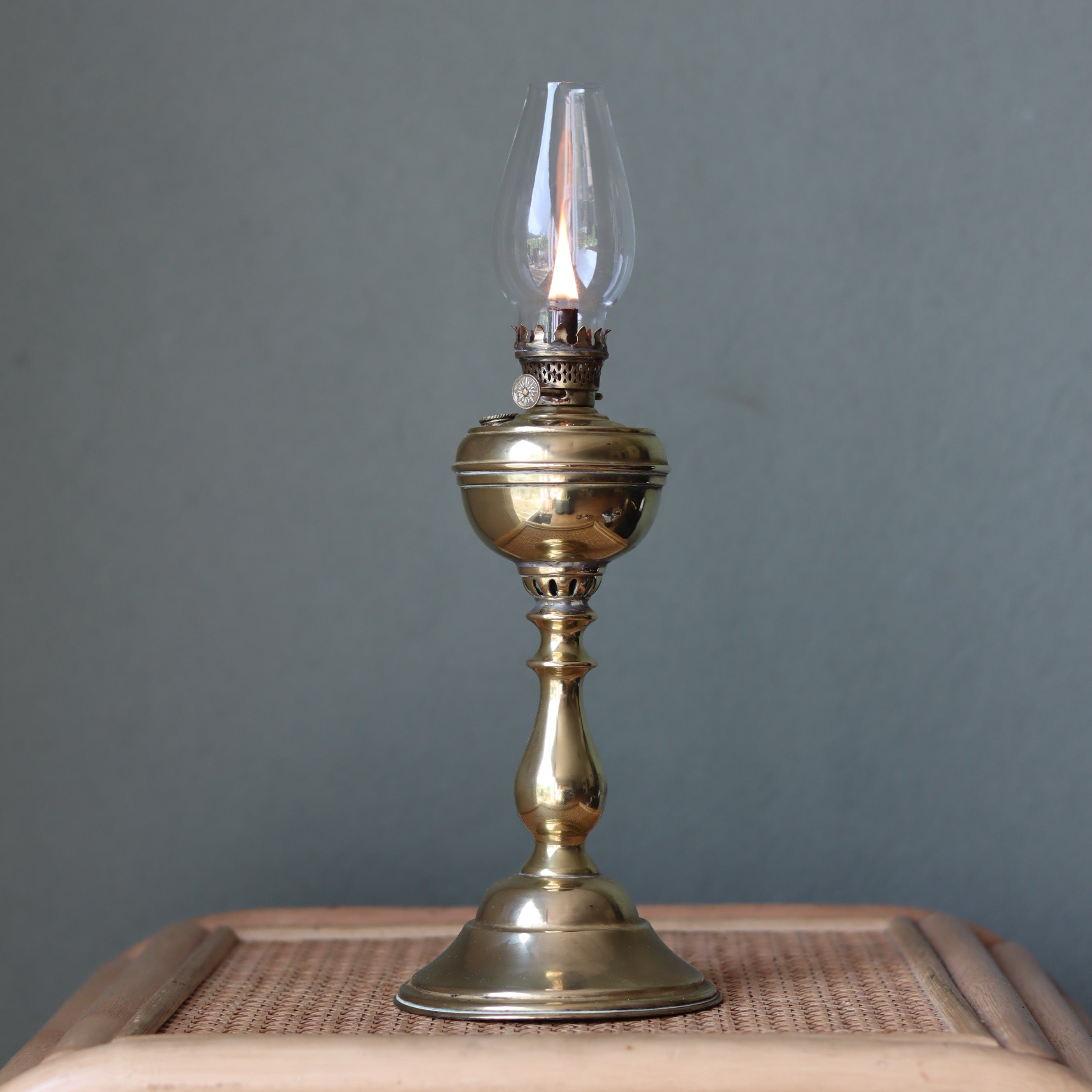 Rare Antique Oil Lamp with Unique Hollow Wick – Elegant Brass Design (c.1900–1930) shown lit on wooden surface.
