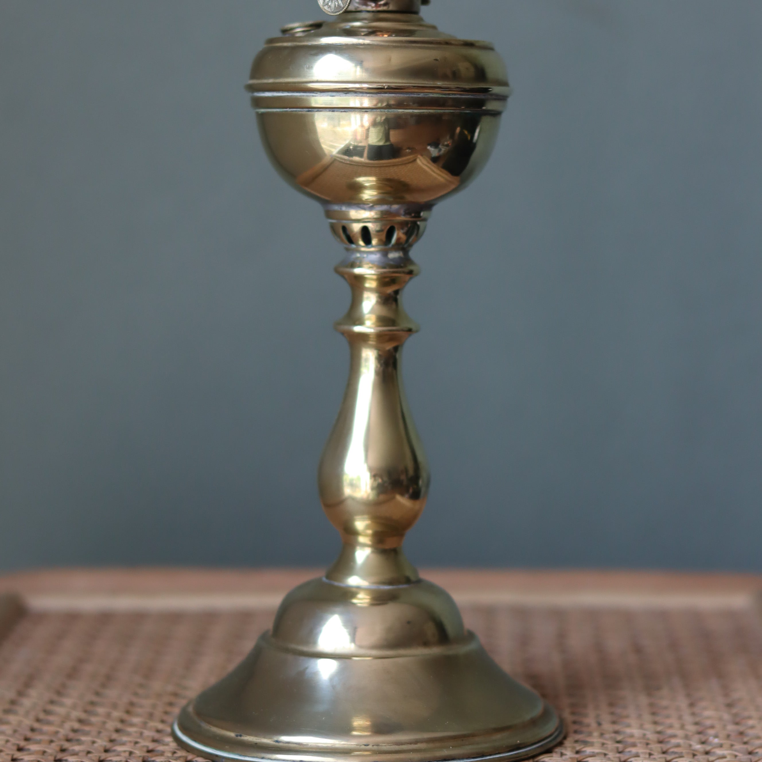 Rare Antique Oil Lamp with Unique Hollow Wick – Elegant Brass Design (c.1900–1930) standing on woven surface.