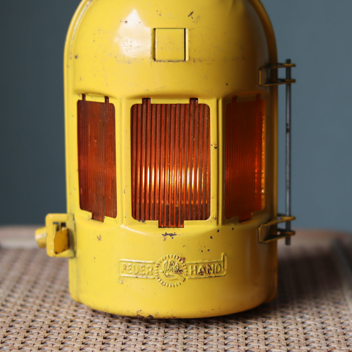 Vintage Feuerhand Yellow Roadwork Lantern – Tealight Safety Lamp (1960s/70s) showing the brand and protective yellow oil lamp casing.