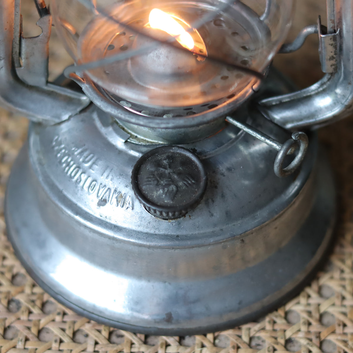 Vintage Mewa Hurricane Lantern – Model 864 (1978) close-up of the metal oil lamp base and lit flame detail