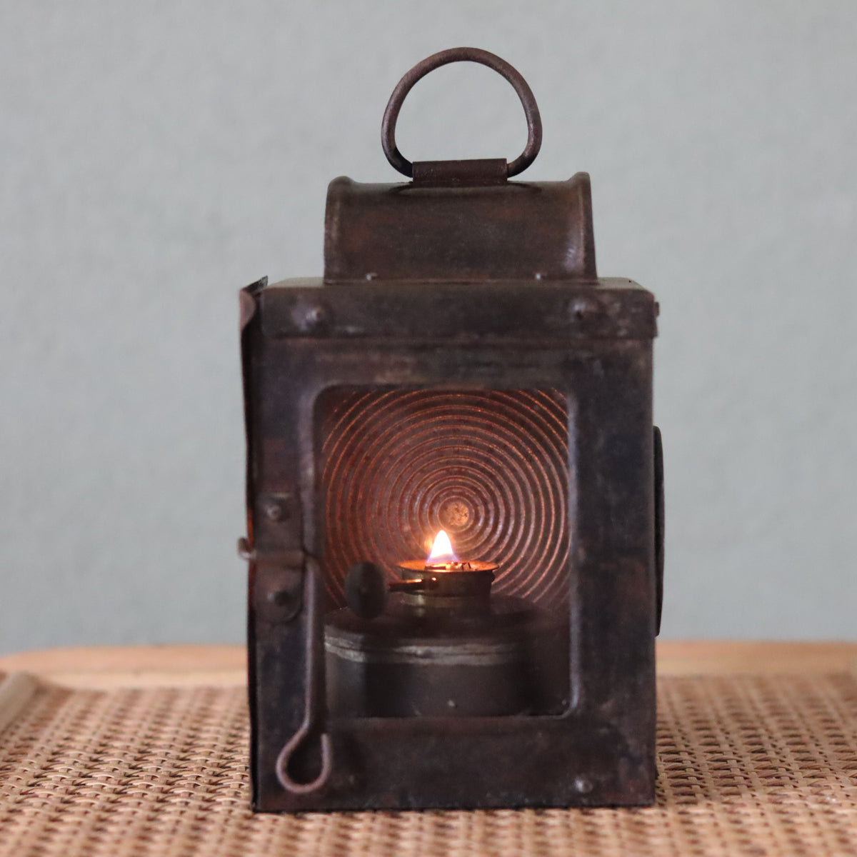 Rare Vintage Lantern – 1930s Automotive or Carriage Lamp showing lit oil lamp with textured glass and metal frame