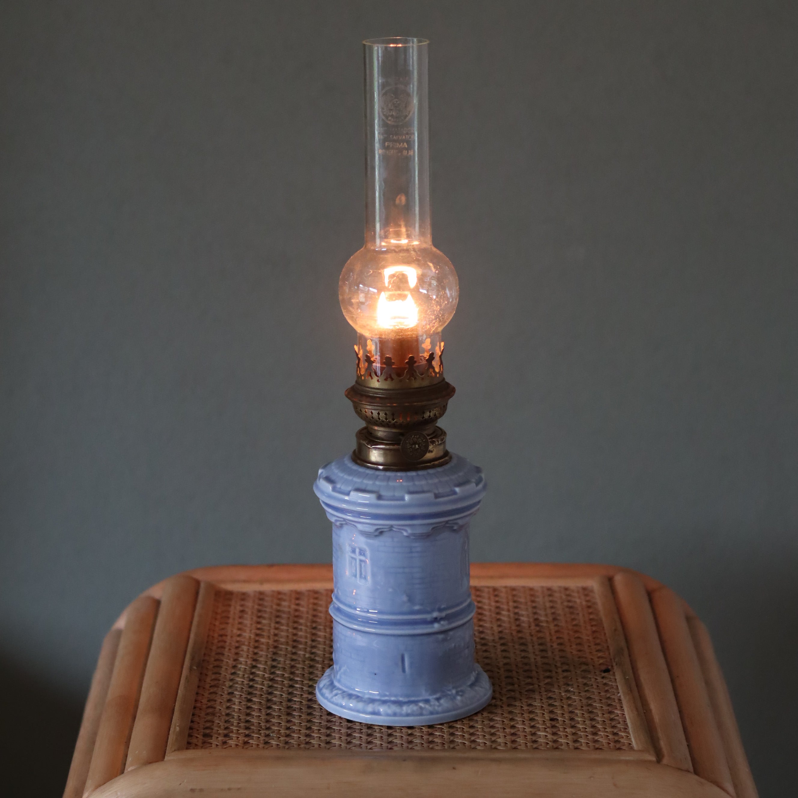 Rare Vintage Ceramic Oil Lamp – Tower Design with Wild & Wessel Burner (1930s) lit on wicker table surface