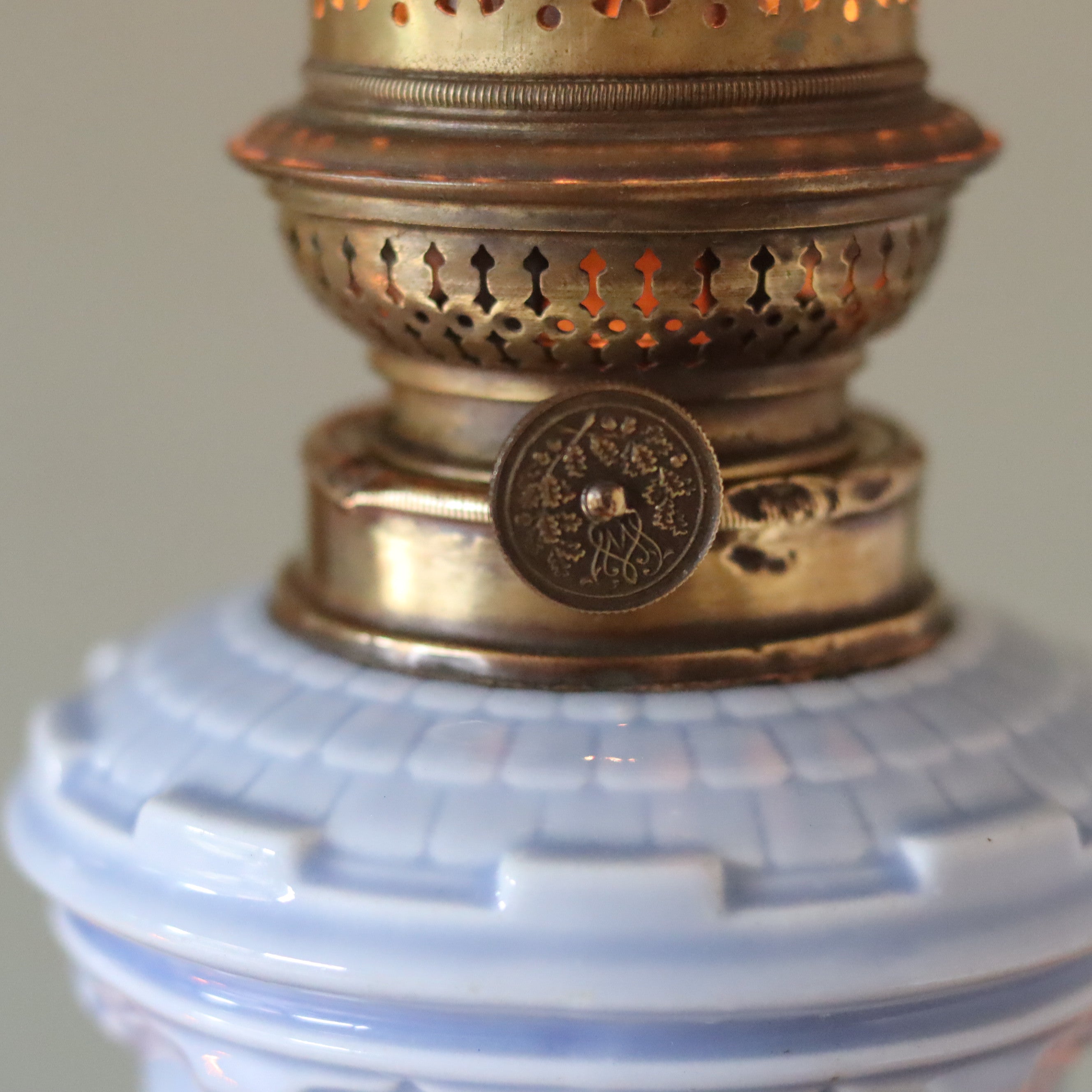 Rare Vintage Ceramic Oil Lamp – Tower Design with Wild & Wessel Burner (1930s) close-up on brass burner and light blue ceramic base