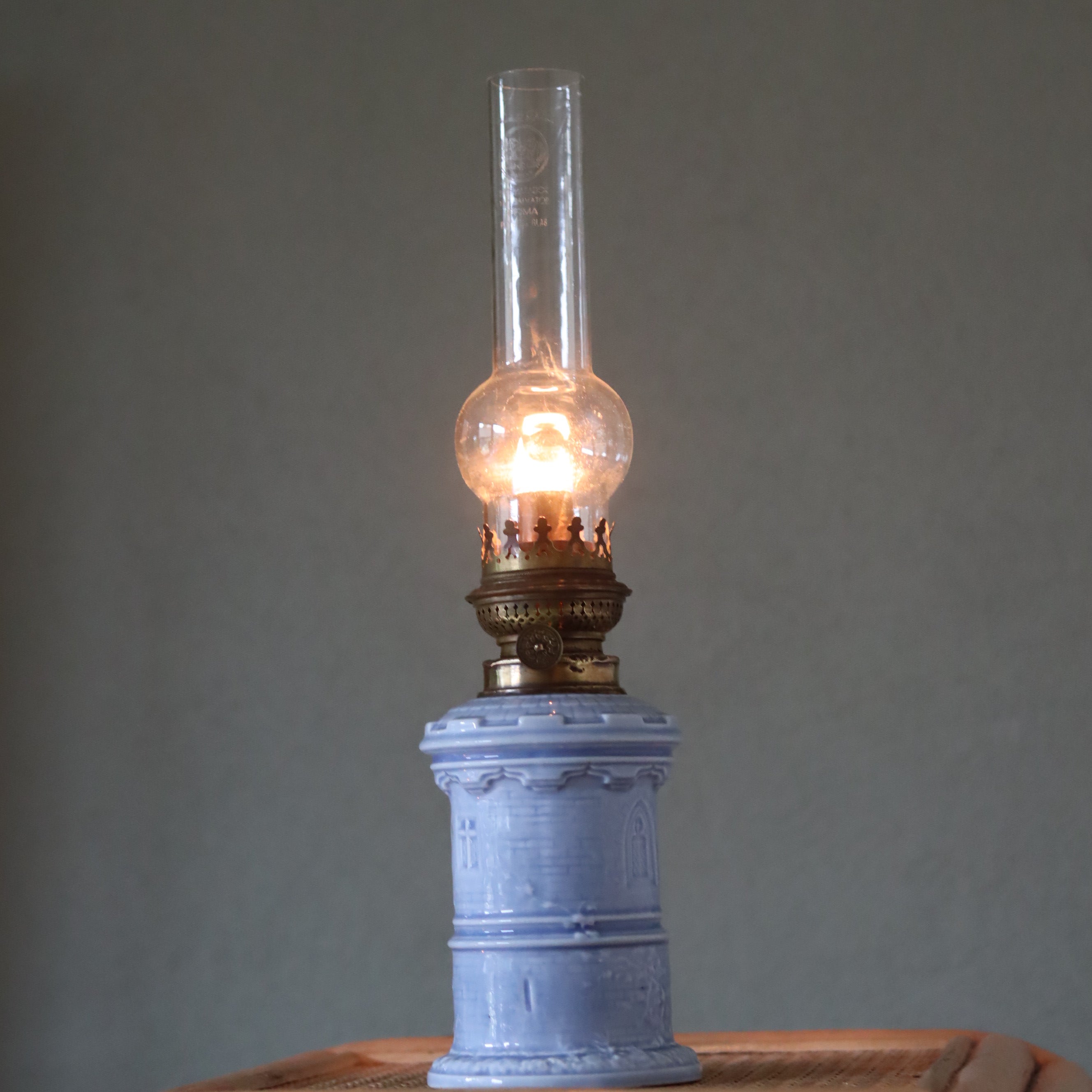 Rare Vintage Ceramic Oil Lamp – Tower Design with Wild & Wessel Burner (1930s) illuminated on blue ceramic base