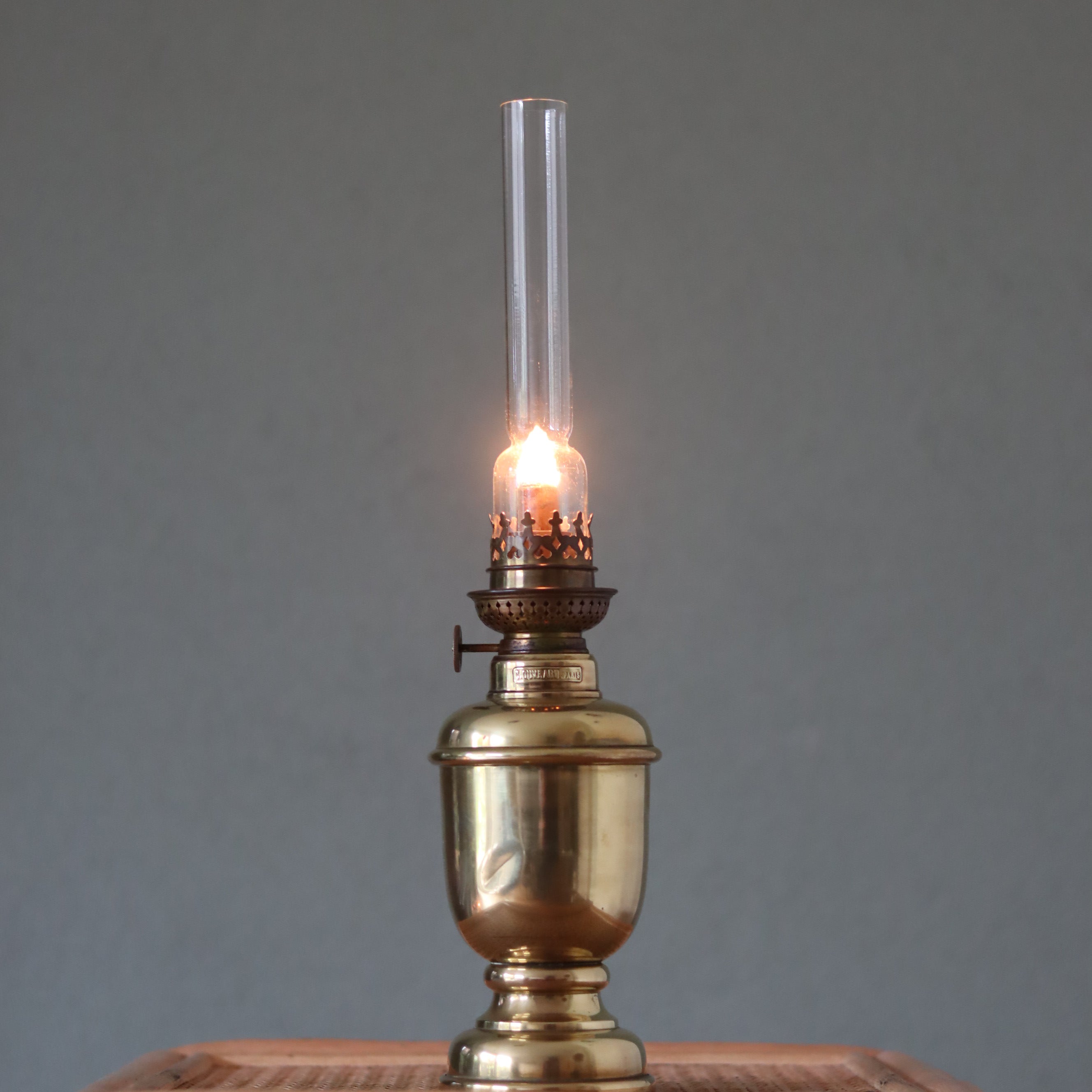 Rare Heavy Oil Lamp – C. Ouvrard Paris with Wild & Wessel Burner, Circa 1930s–1950s illuminated on wooden surface
