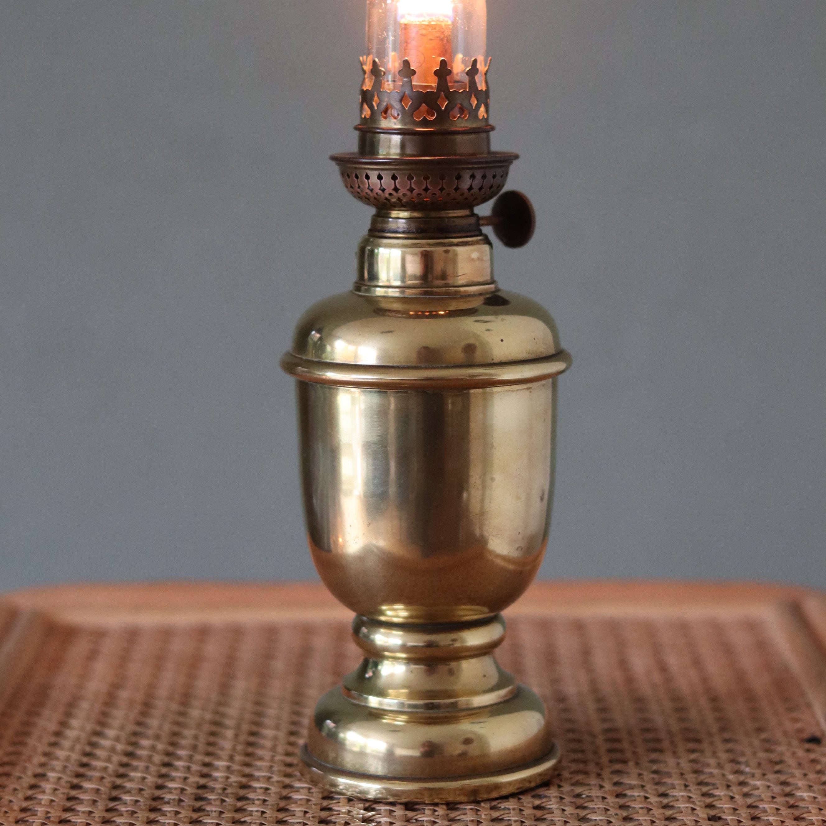 Rare Heavy Oil Lamp – C. Ouvrard Paris with Wild & Wessel Burner, Circa 1930s–1950s showcasing antique brass design and lit burner.