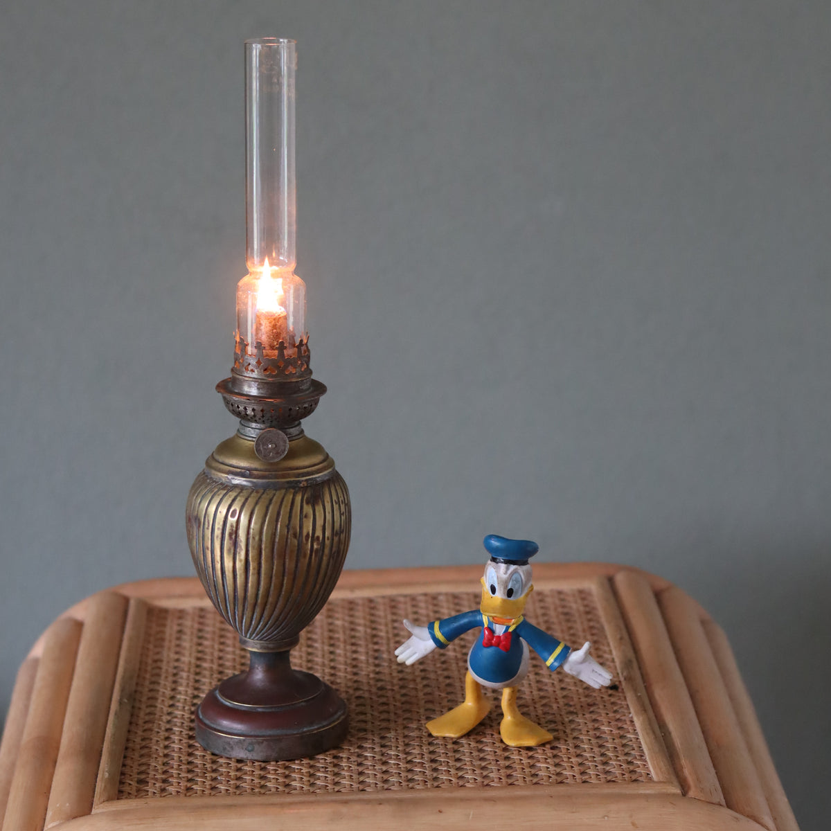 Vintage Oil Lamp with Wild & Wessel Burner – 1930s lit on a wooden surface showcasing antique design elements.