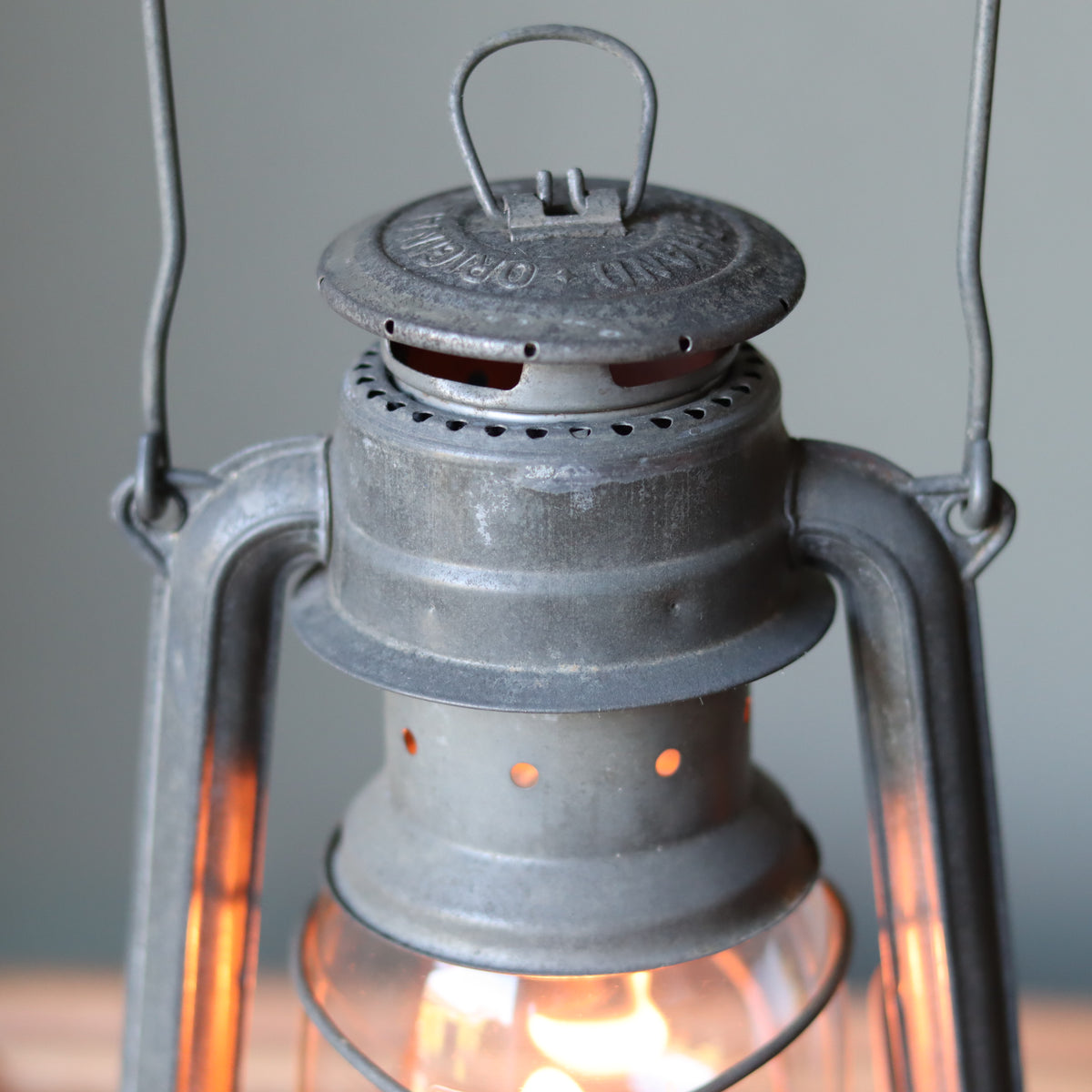 Restored Vintage Feuerhand Baby 275 Hurricane Lantern – Western Germany showcasing classic metal oil lamp design with lit flame inside glass chamber