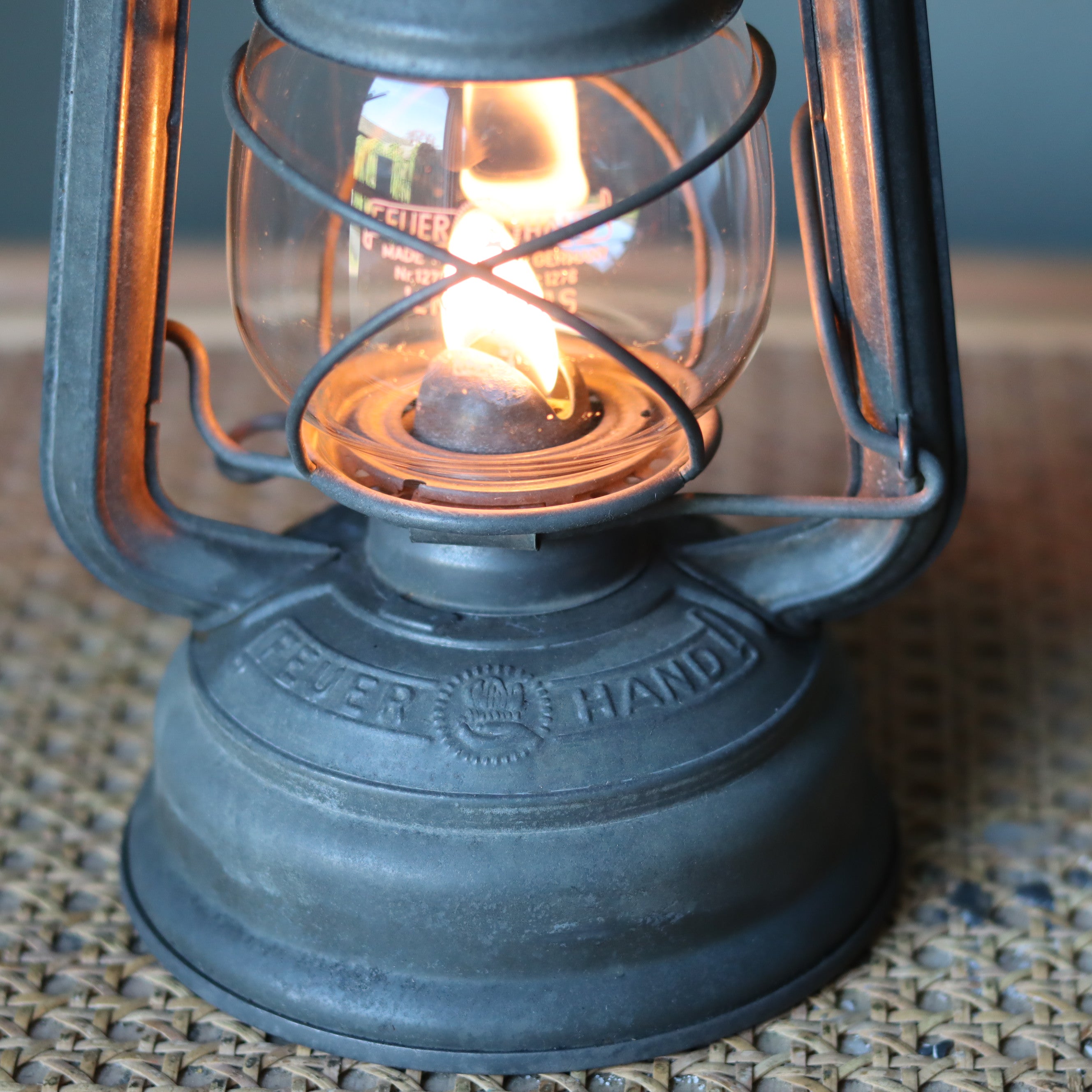 Restored Vintage Feuerhand Baby 275 Hurricane Lantern – Western Germany close-up showing the glowing oil lamp flame and metal details