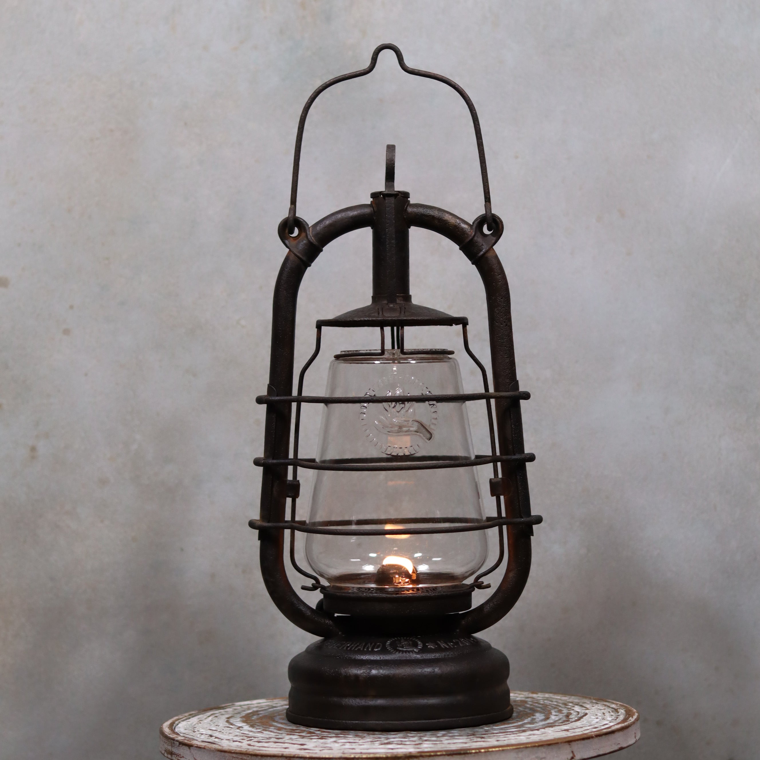 Vintage Feuerhand 201 Storm Lantern – Rare Glass – 1920s/1930s – Original Parts oil lamp with classic metal frame and glowing flame.