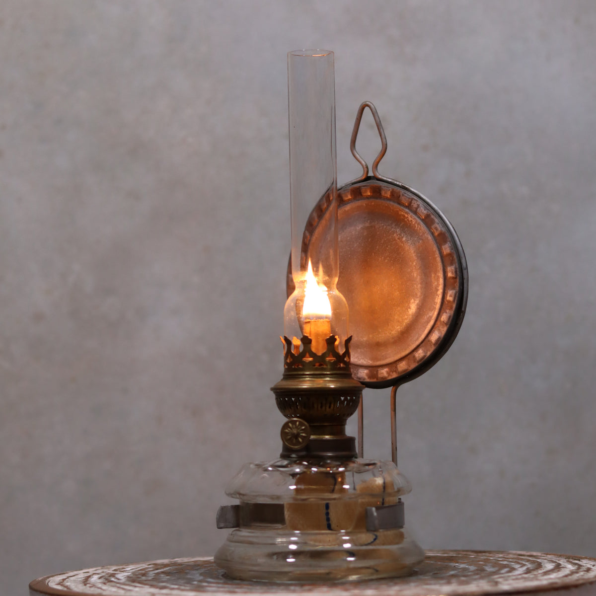Vintage Oil Lamp – Classic Wall or Kitchen Lamp with Silver Reflector lit, showcasing its elegant vintage design and warm glow.