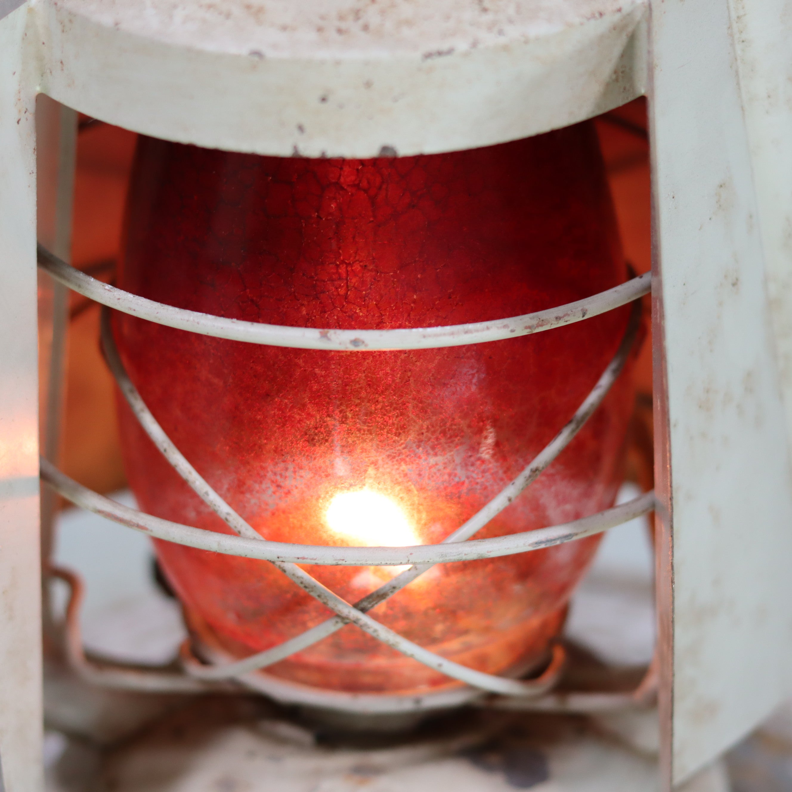 Vintage French ALG Hurricane Lantern with Signal Hood – Red Painted Glass (1960s/70s) showing glowing oil lamp inside vintage casing