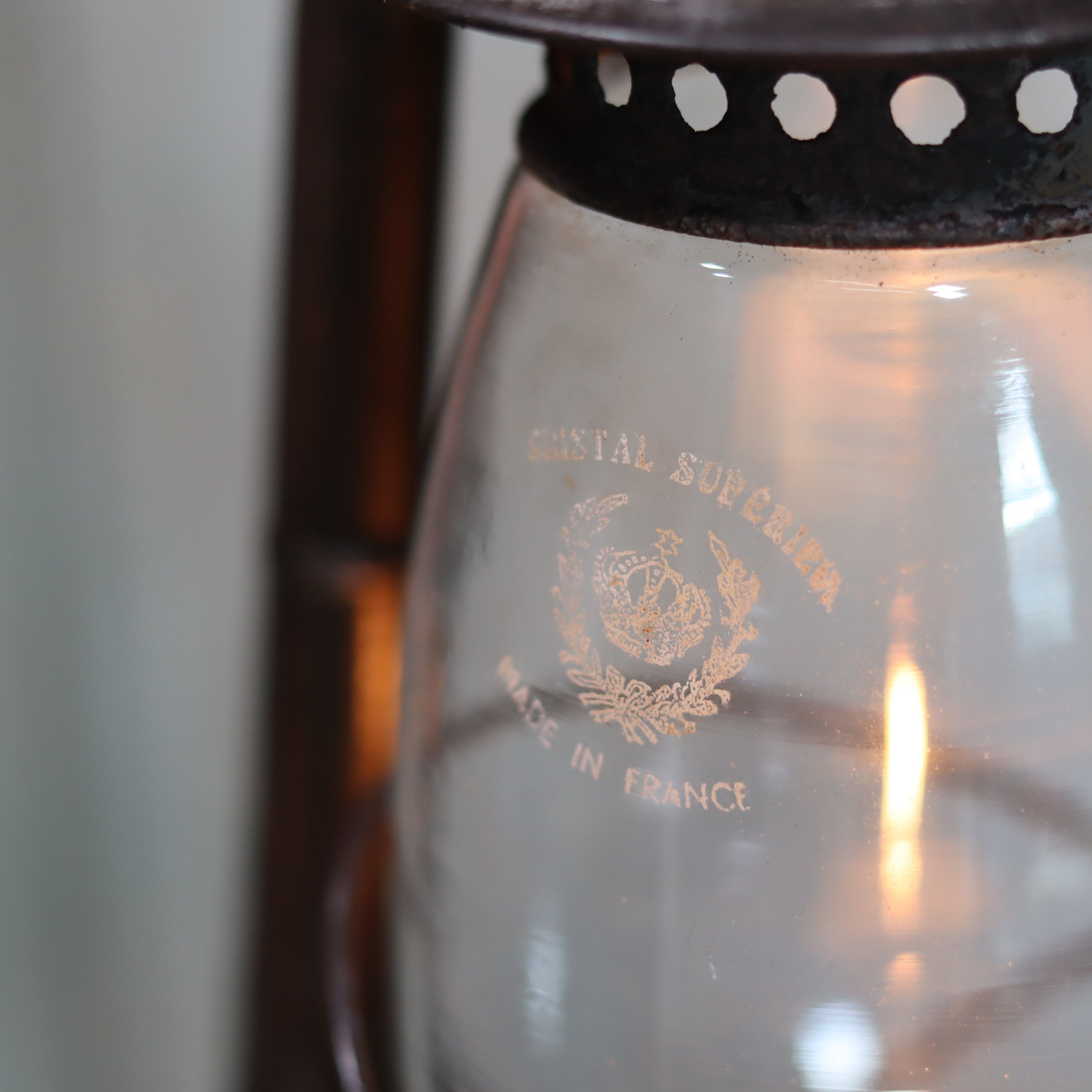 Close-up of Vintage French ALG No. 6 Hurricane Lantern – Cristal Supérieur Glass (1930s) oil lamp flame and brand logo.