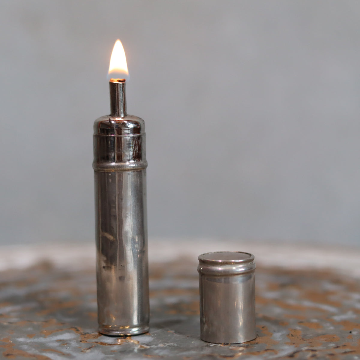 Rare Antique Pigeon Pocket Oil Lamp – Model 60, Complete and Functional, Circa 1918–1930 with lit flame and cap beside it