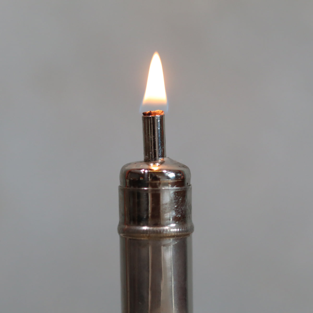 Rare Antique Pigeon Pocket Oil Lamp – Model 60 lit flame showing complete and functional metal oil lamp circa 1918–1930