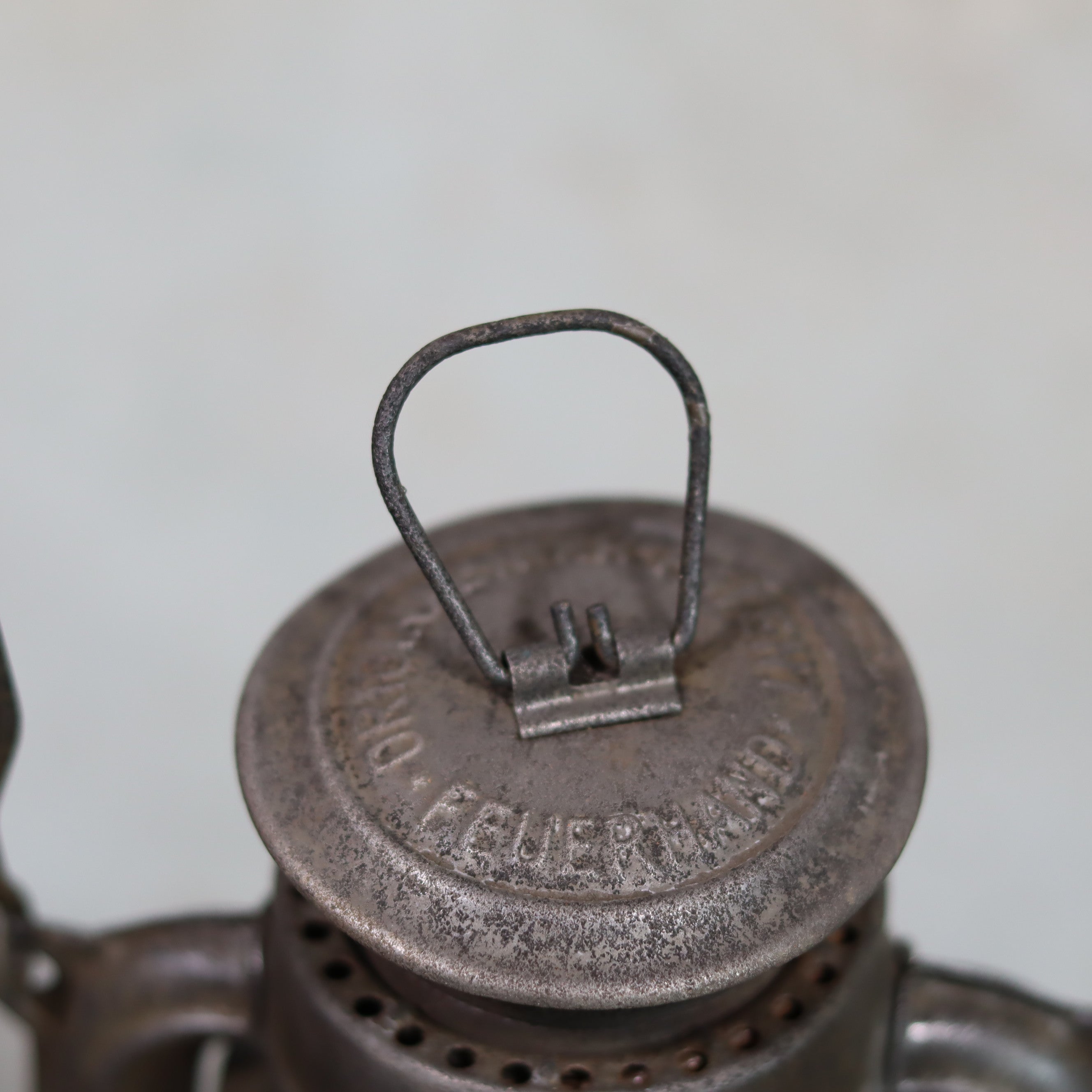Vintage Feuerhand Hurricane Lantern – Model 276 (1950s) with rare glass showing close-up of metal top and handle of oil lamp