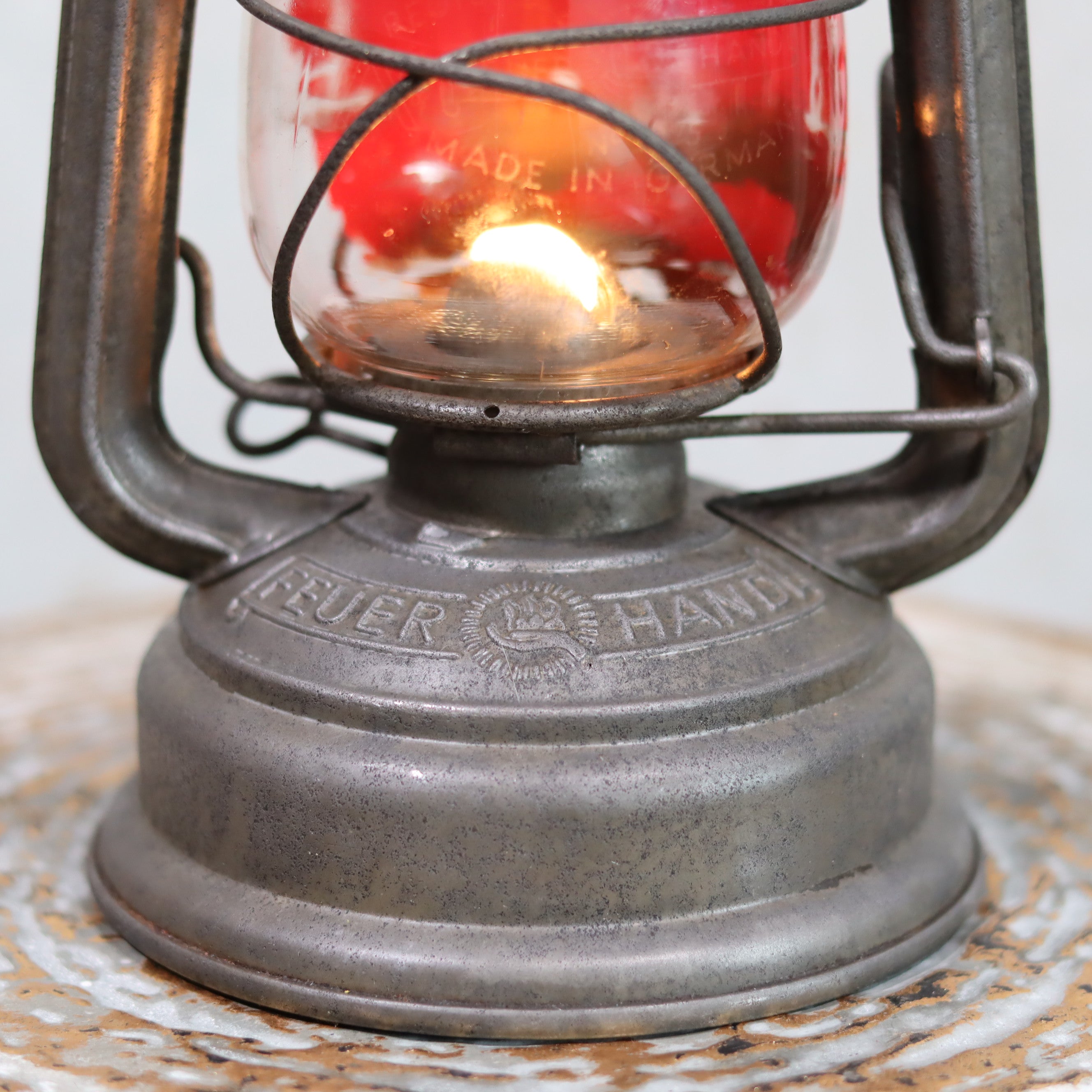 Vintage Feuerhand Hurricane Lantern – Model 276 (1950s) with rare glass showing lit oil lamp base and brand engraving