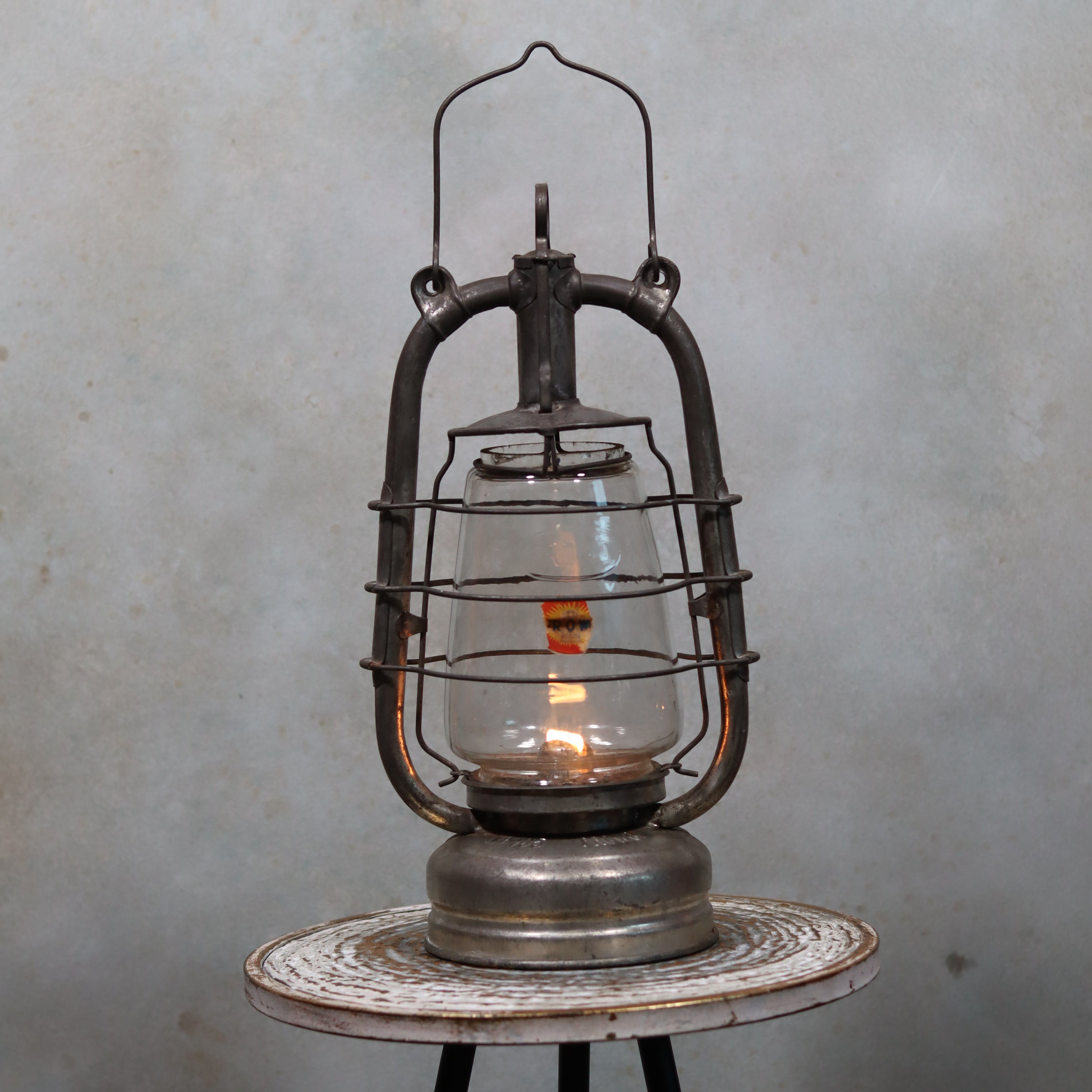 Vintage Frowo 105 Hurricane Lantern – Original Glass & Partial Sticker showing authentic German oil lamp with flame on rustic table