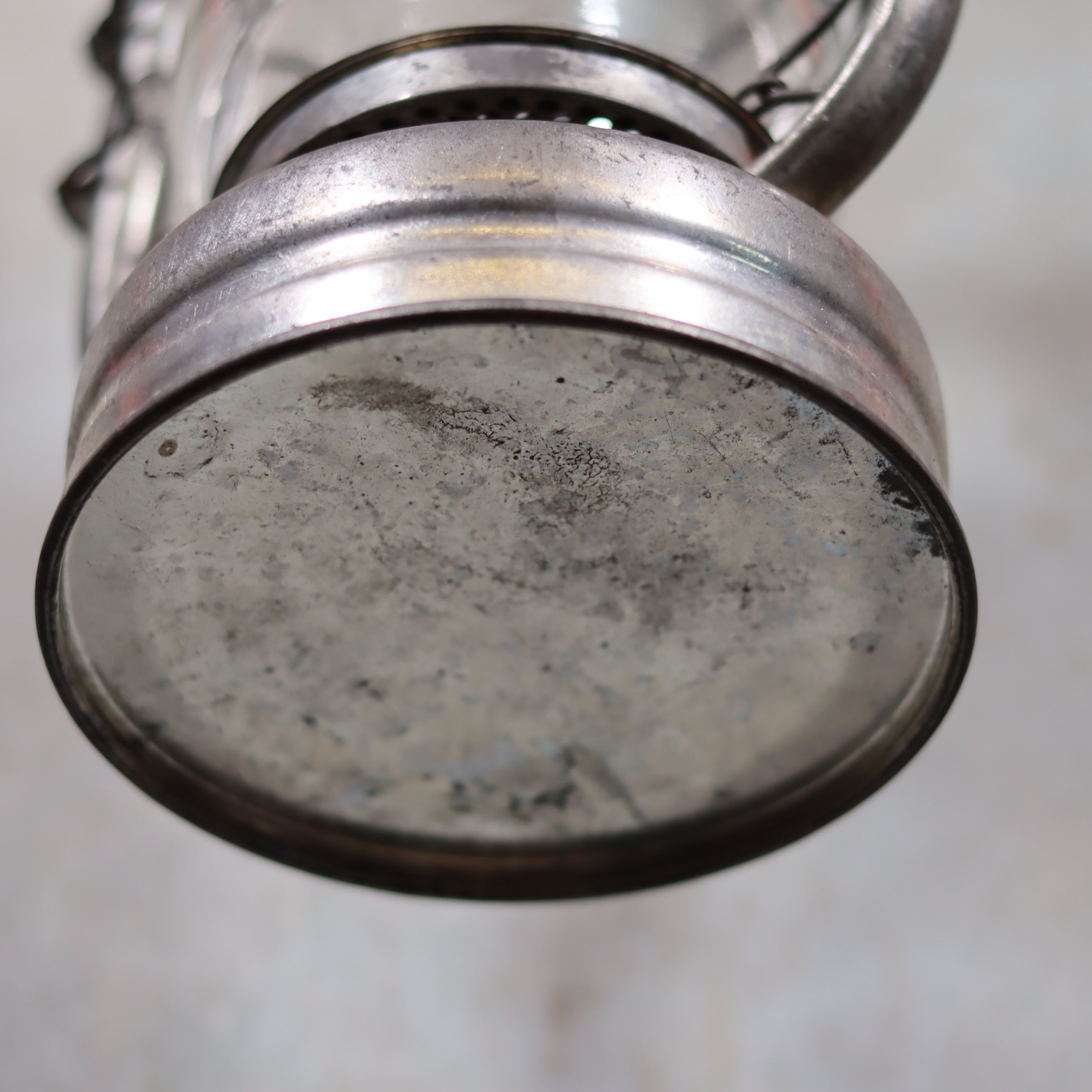Base view of Vintage Frowo 105 Hurricane Lantern – Original Glass & Partial Sticker oil lamp showing wear and metal details