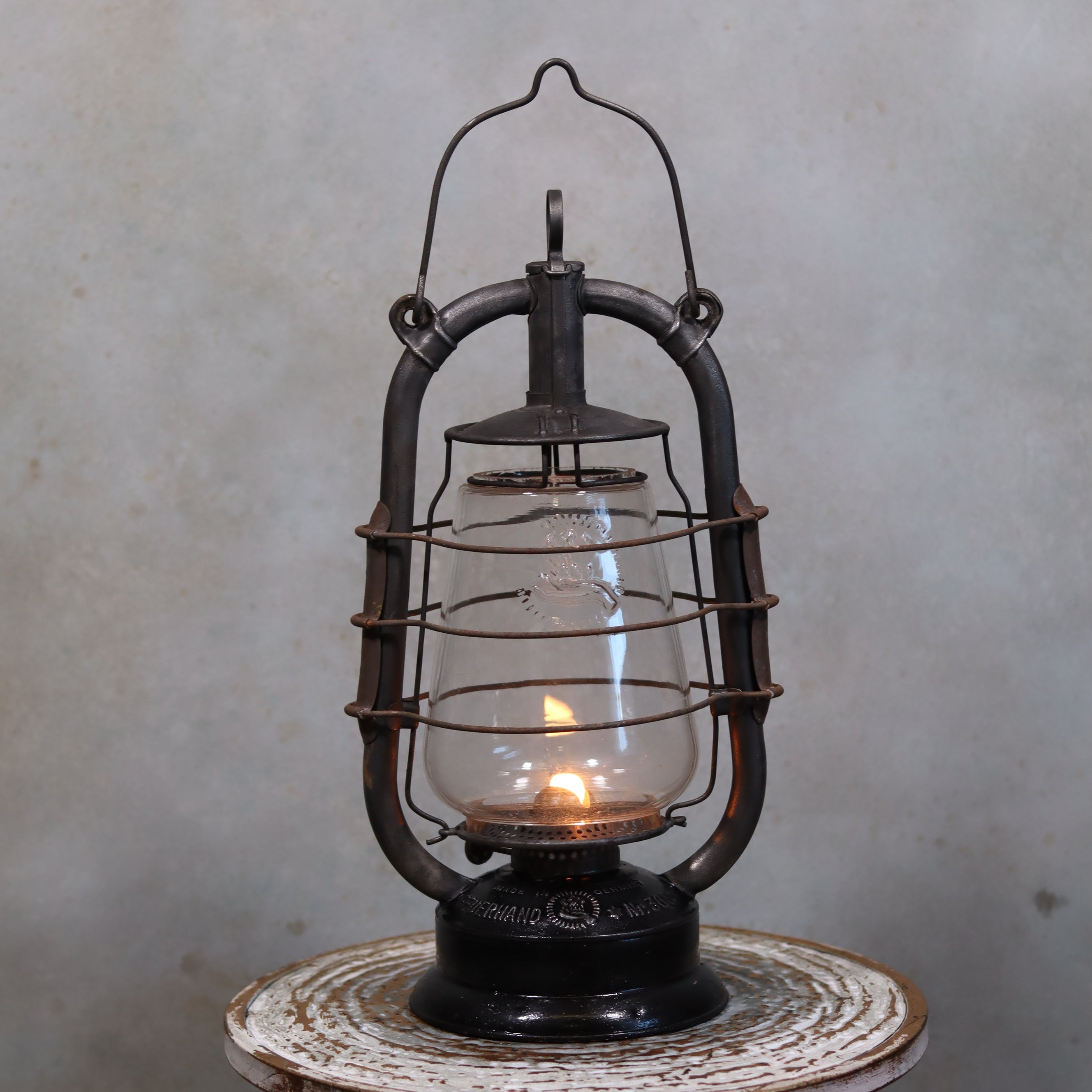 Rare Feuerhand 305 Hurricane Lantern – German Vintage Model with Black Tank (1930–1941) glowing oil lamp