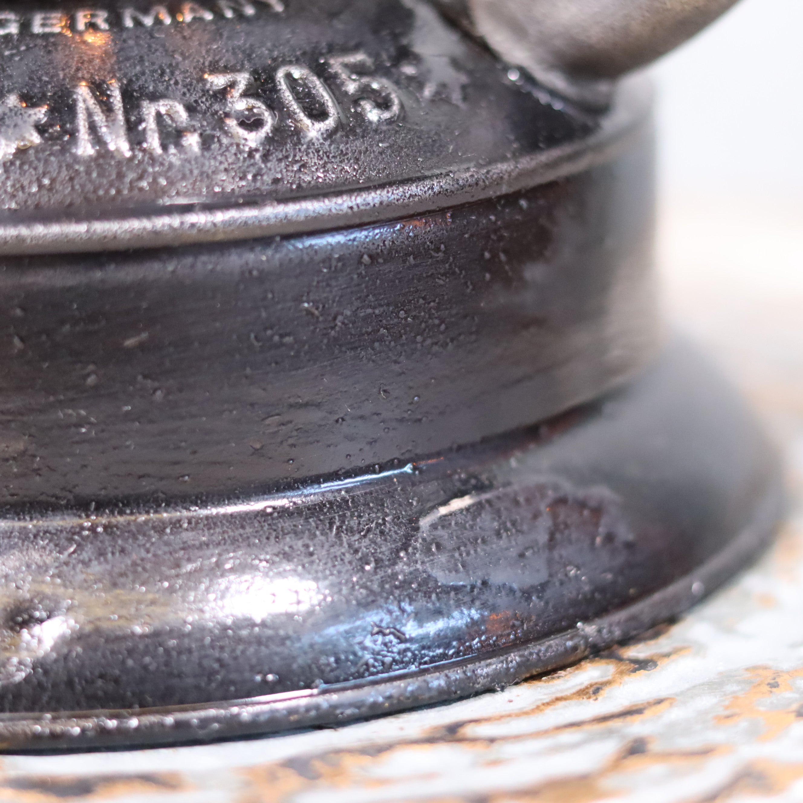Close-up detail of the Rare Feuerhand 305 Hurricane Lantern – German Vintage Model with Black Tank (1930–1941) oil lamp base.