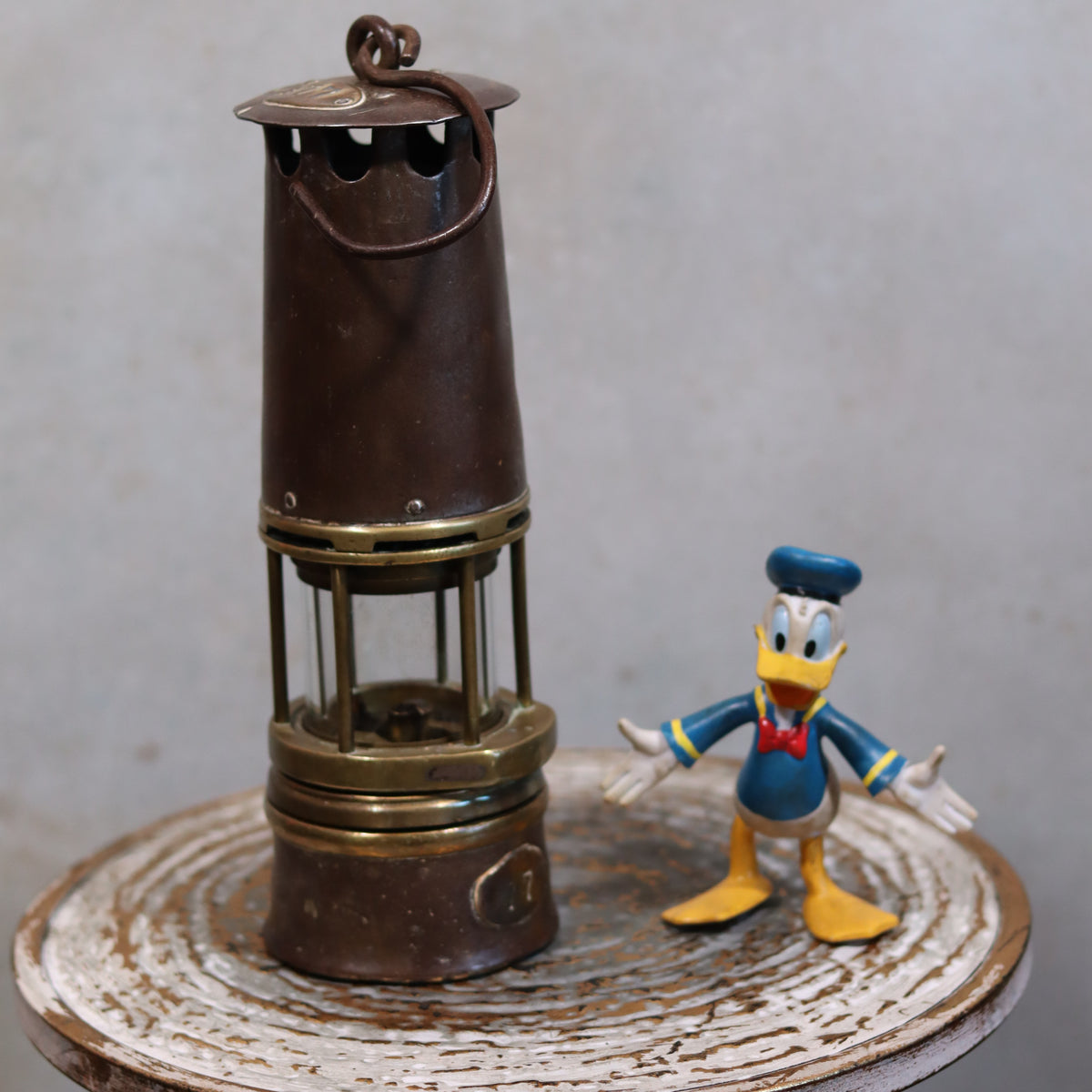 Heavy Vintage Mining Lamp – Numbered 77 – Jenaer Glass – 1930s–1950s displayed with vintage character figure on rustic surface